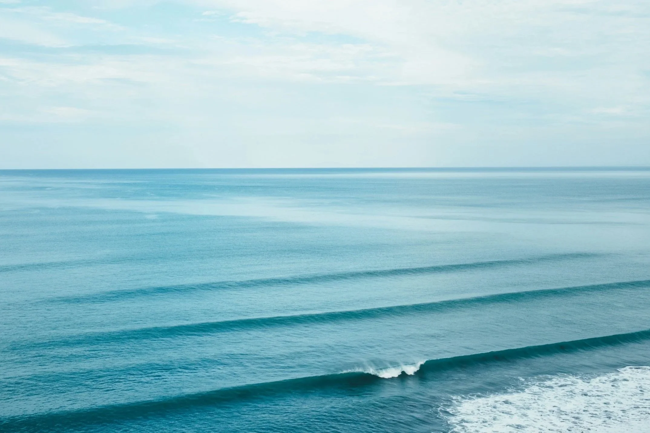 Calm ocean with gentle waves and a cloudy sky