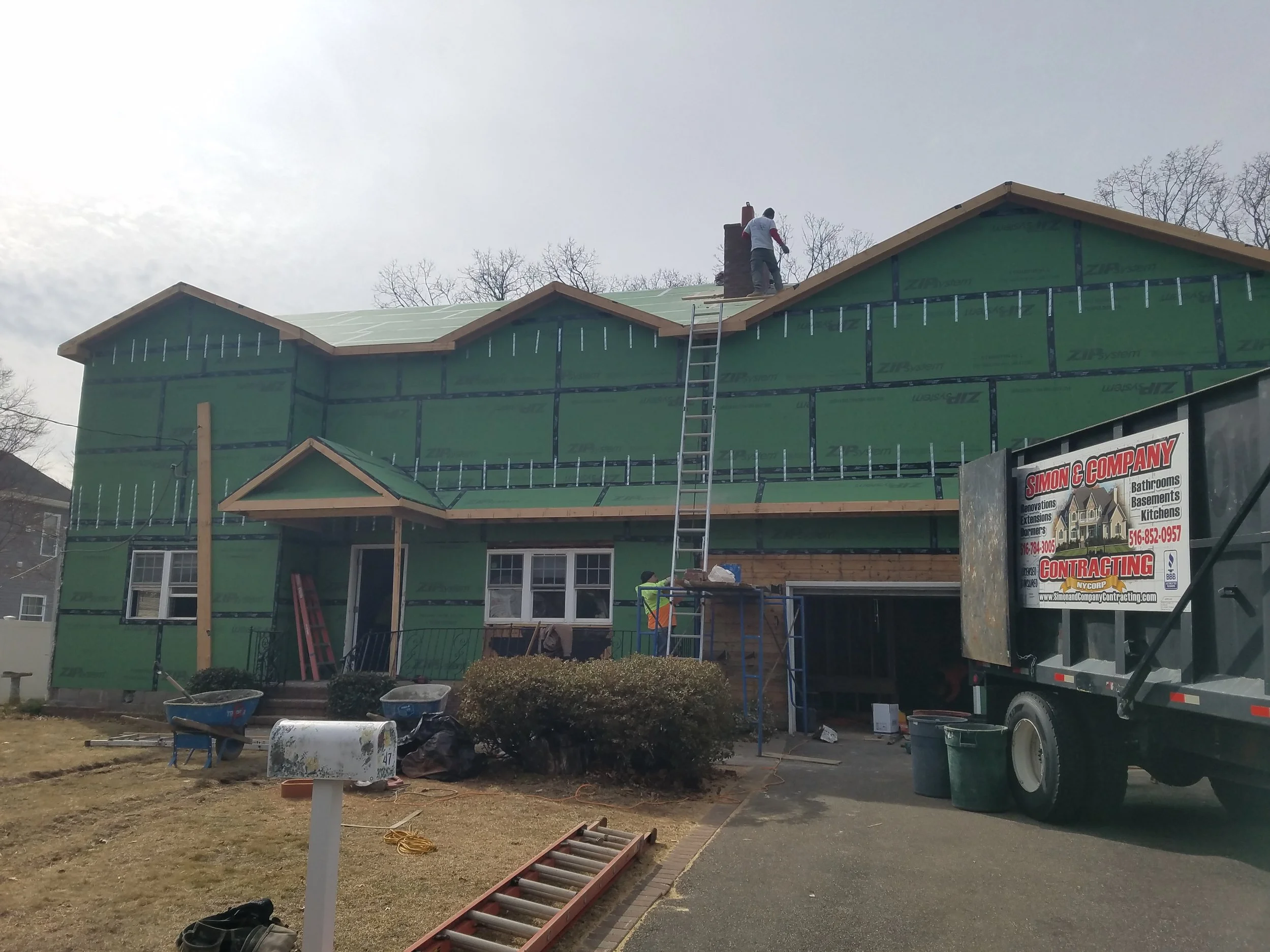 Oranssi technician working on a roof project