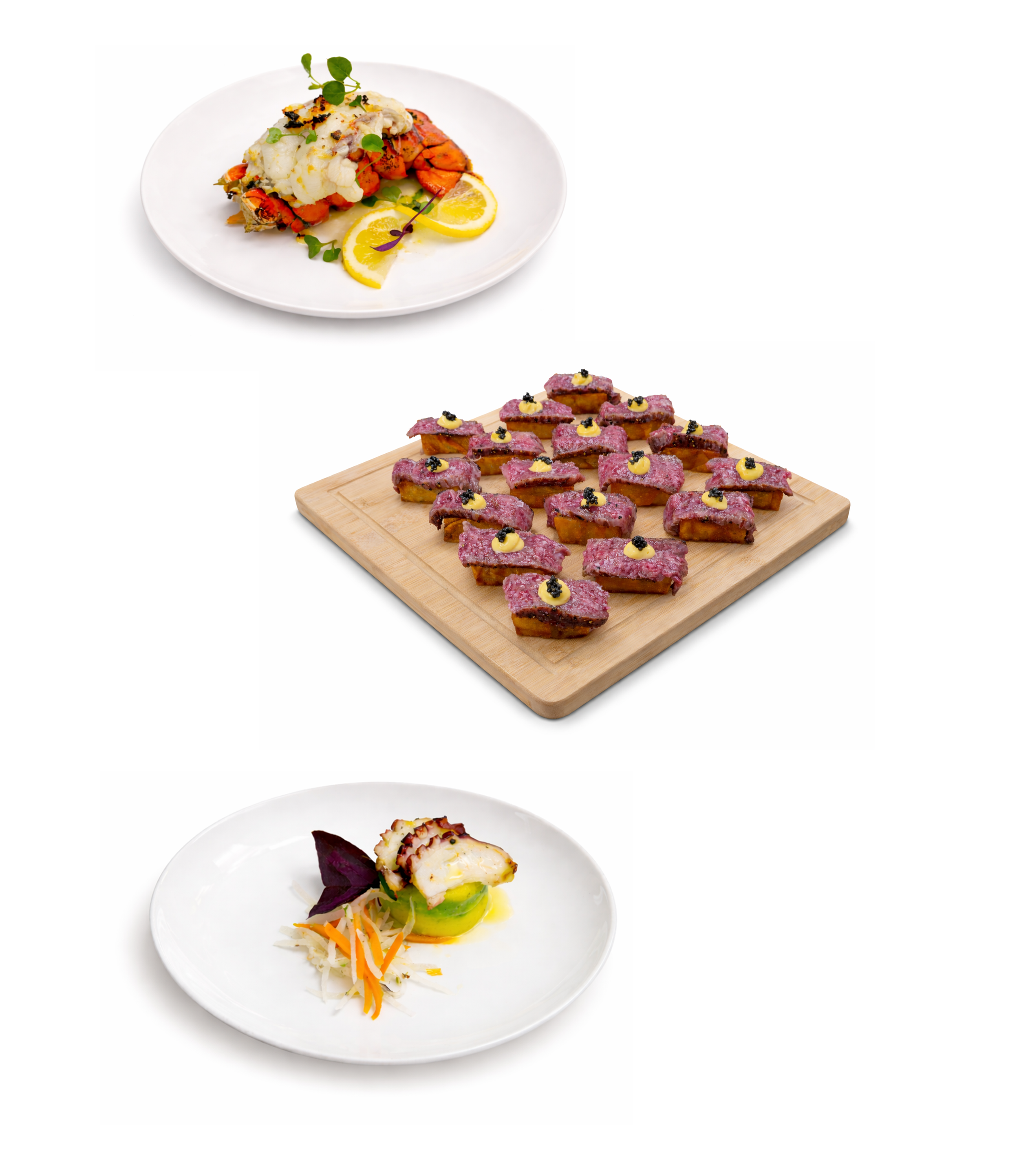 Three plates of gourmet food: top plate with vegetables and lemon slices, middle plate with pink frosted bite-sized desserts topped with black and yellow garnish on a wooden board, bottom plate with seafood and vegetables