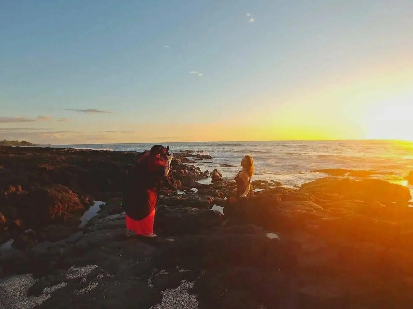 Photographer taking pictures of a woman on the beach