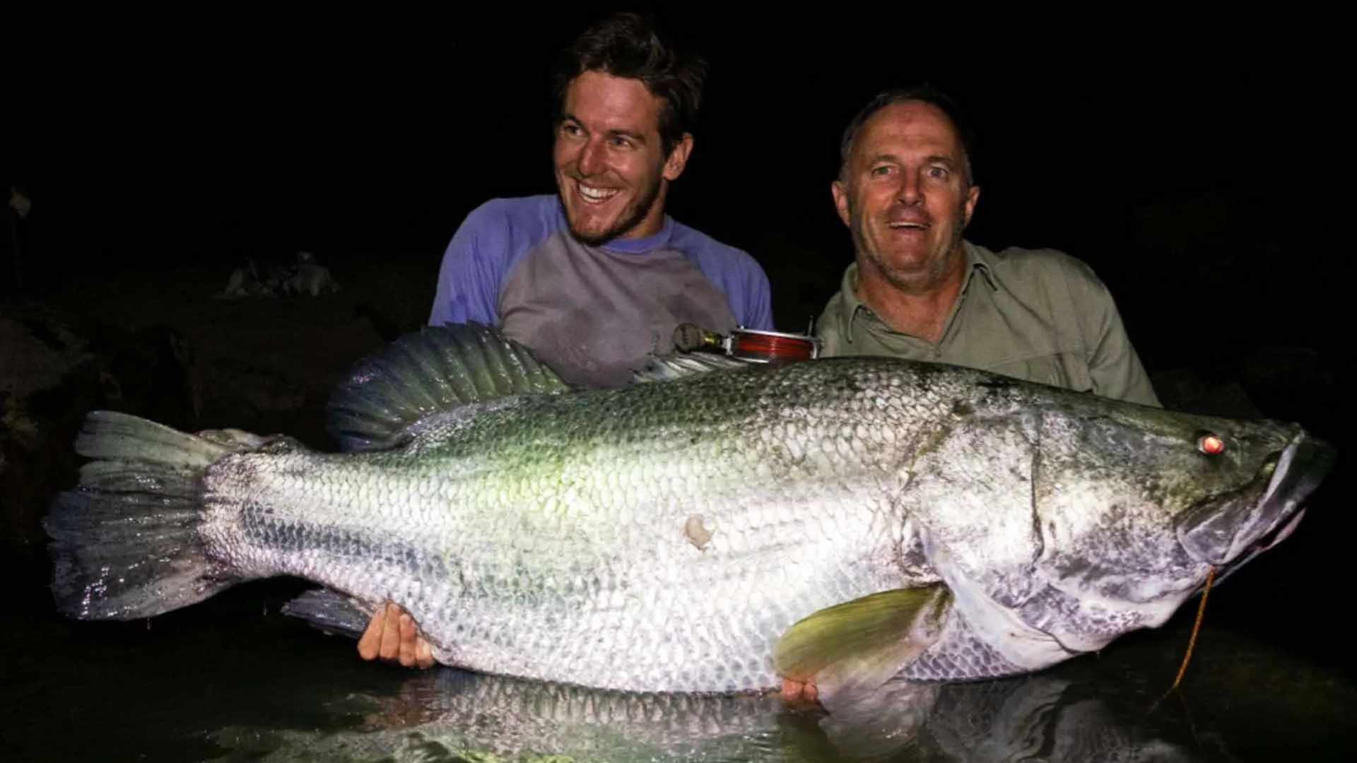 Angler holding a huge perch caught while fishing from Gassa Camp on Africa’s Faro River.