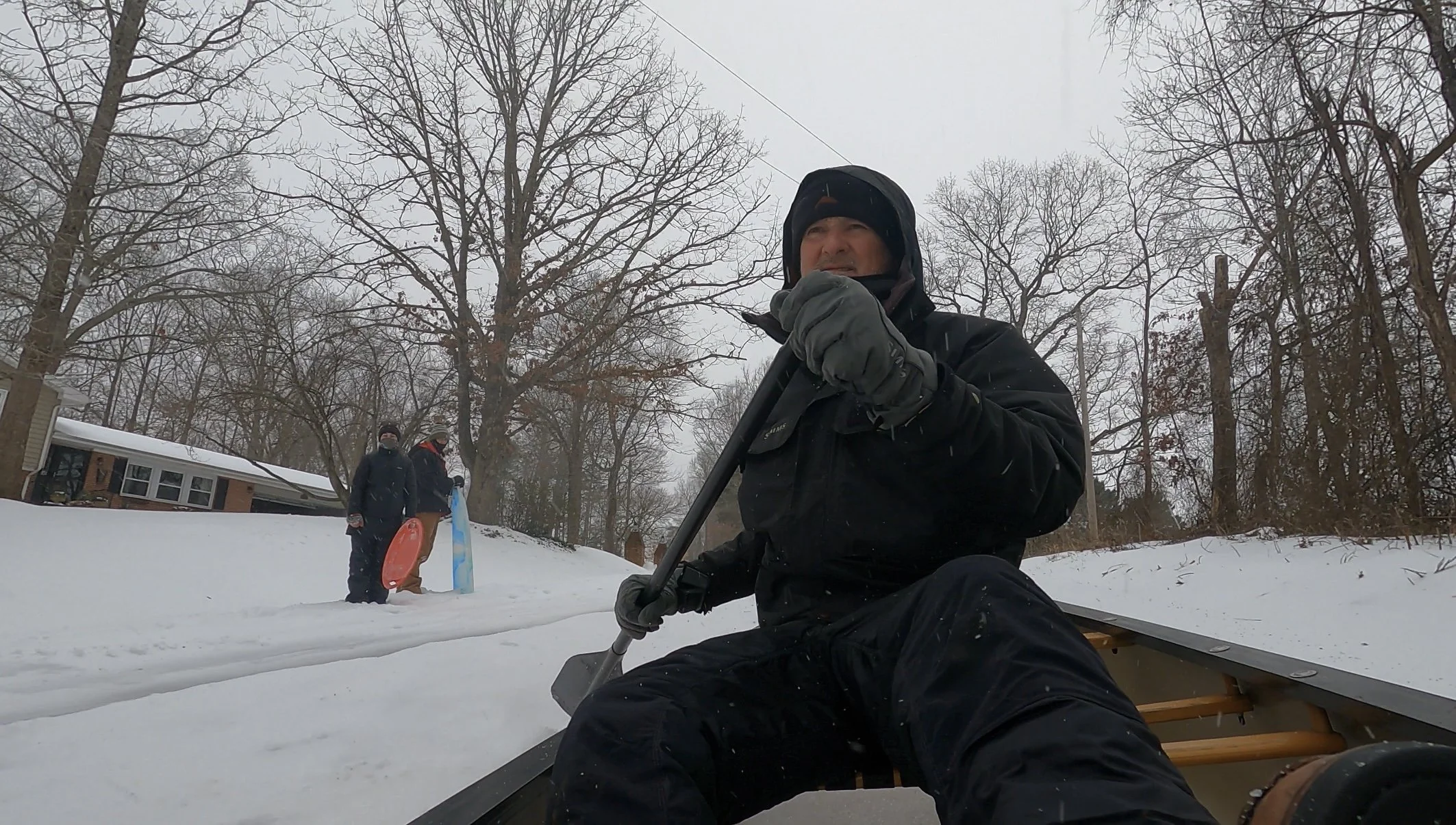 man-shoveling-snow-street-sledding-winter-storm-central-virginia.jpg