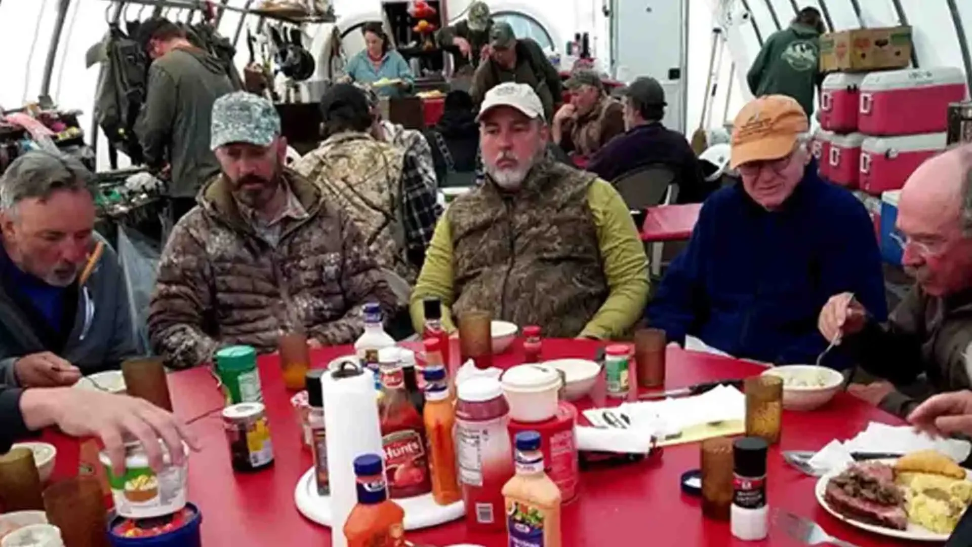 Group of anglers enjoying a hearty meal at the Dave Duncan & Sons lodge in Alaska after a day of fly fishing.