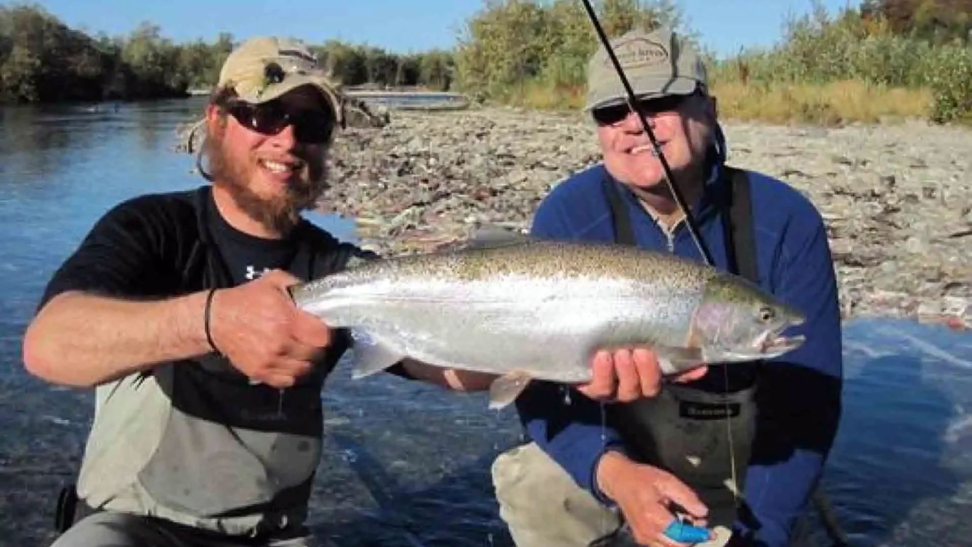 Angler holding trophy rainbow trout caught on Copper River Alaska guided fly fishing trip