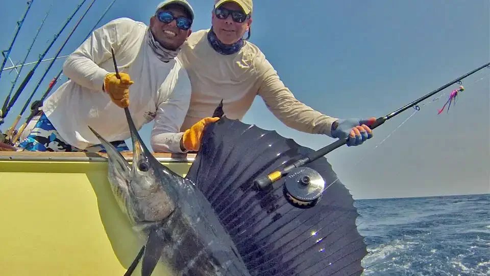 Angler and guide proudly displaying a large sailfish caught during a sportfishing trip in Guatemala