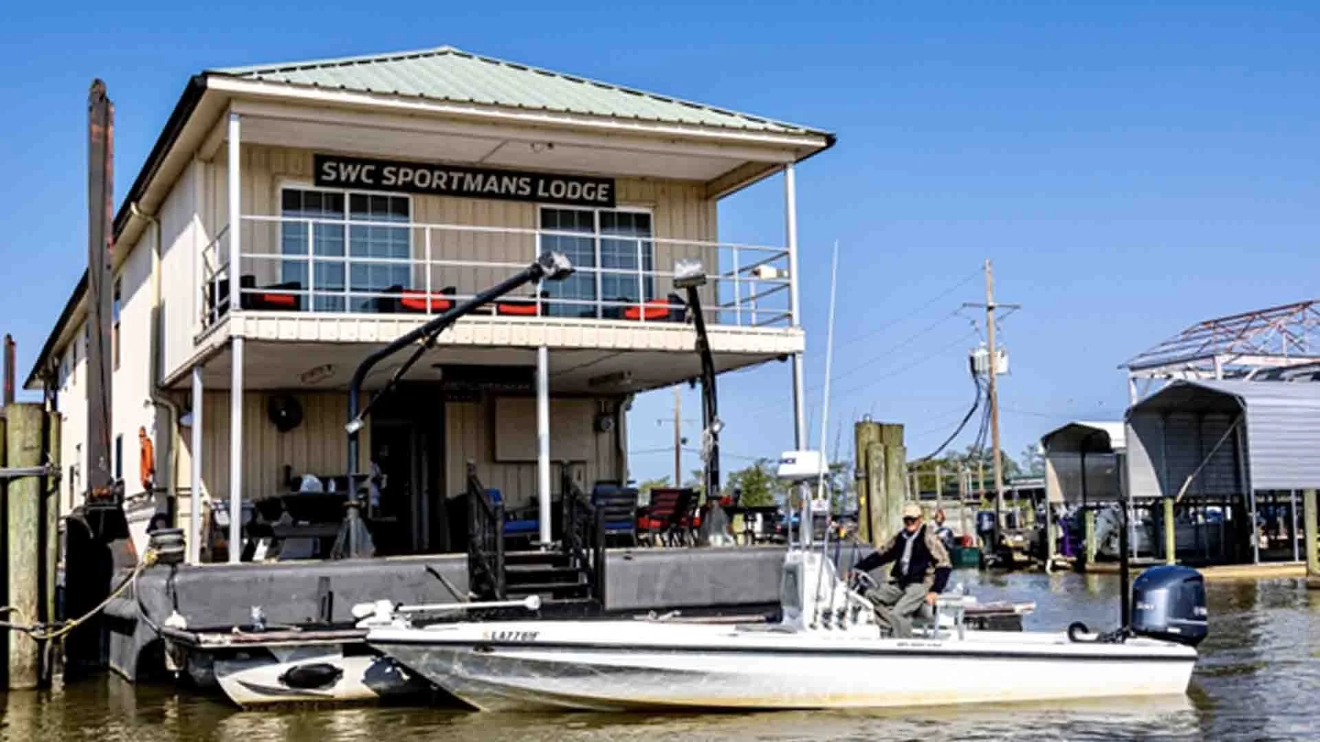 A person in a boat near SWC Sportmans Lodge in Louisiana, ready for redfishing in the salt marsh.