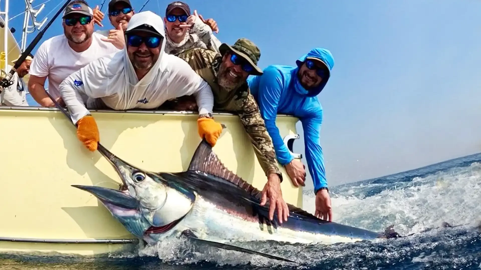 Group of happy anglers aboard the Allure II in Guatemala proudly displaying a marlin they caught at Sailfish Oasis Lodge.