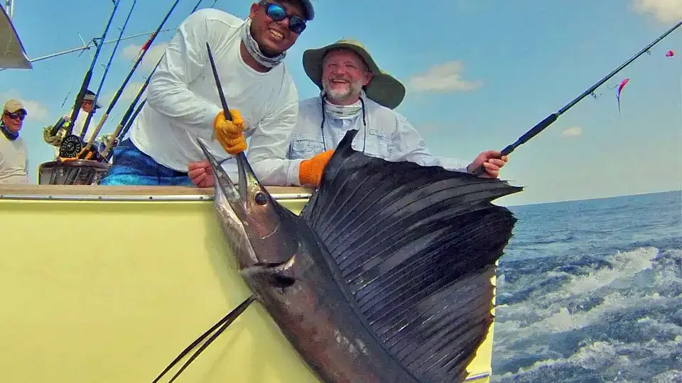 Happy angler and guide in Guatemala displaying a large sailfish caught during a sportfishing trip at Sailfish Oasis Lodge.