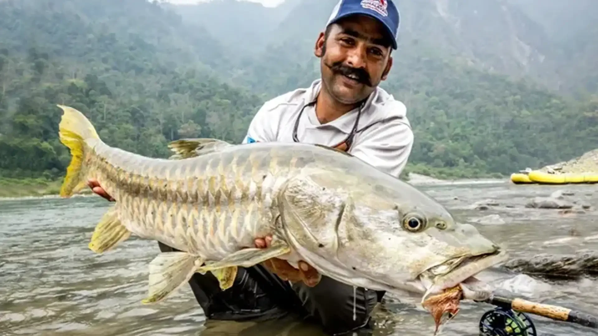 angler-golden-mahseer-fly-fishing-bhutan-river.webp
