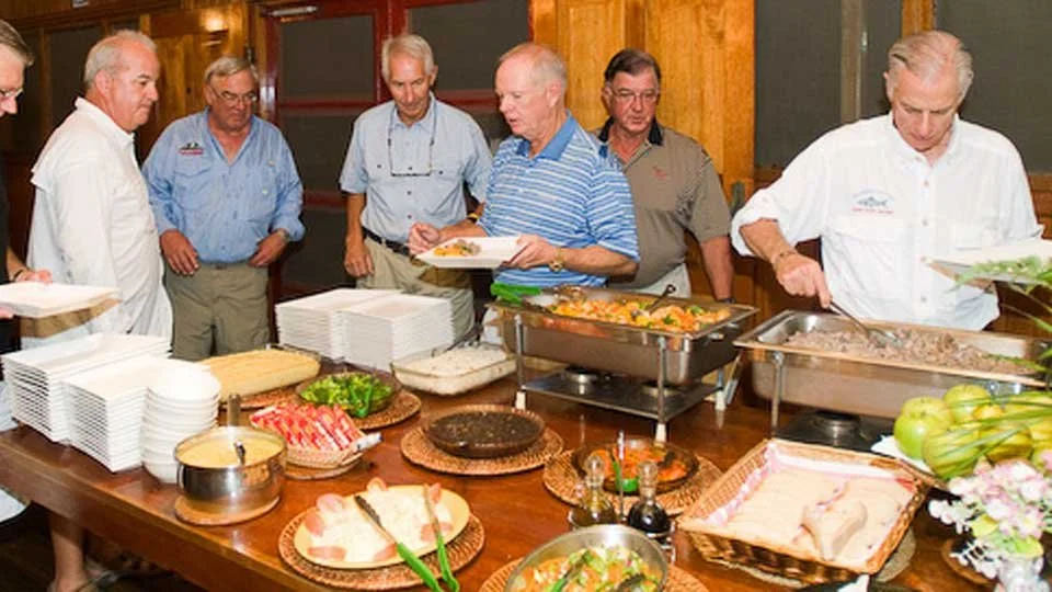 Guests at Silver King Lodge serving themselves dinner from the buffet-style dining area.