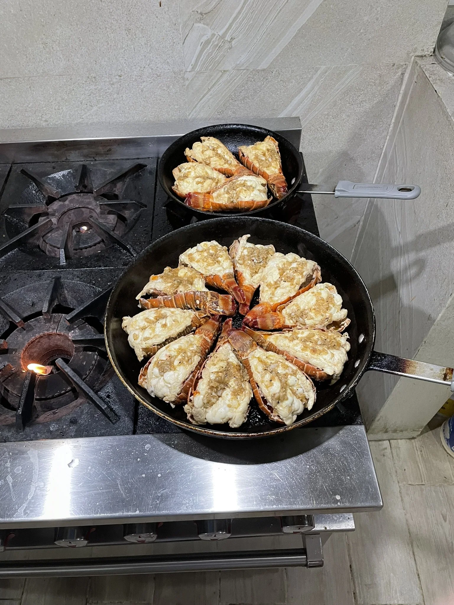 Fresh lobster tails from Ascension Bay being cooked for dinner at Kay Fly Lodge in Punta Allen, Mexico.