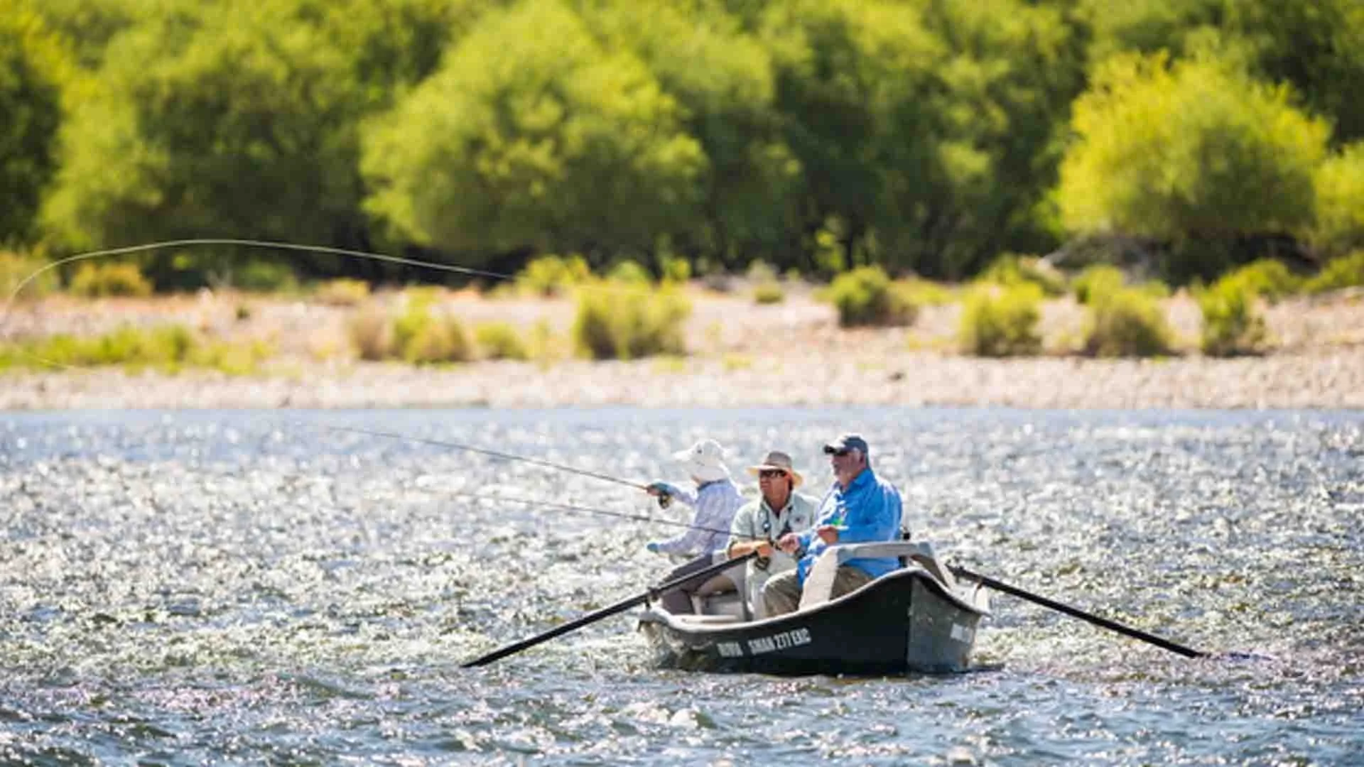 Anglers casting for trout from a boat on the Limay River in Argentina during a guided fishing trip with Three Rivers Lodge.