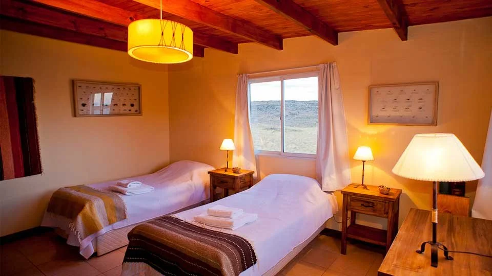 Guest cabins and dining at Estancia Laguna Verde Lodge on Jurassic Lake in Argentina.