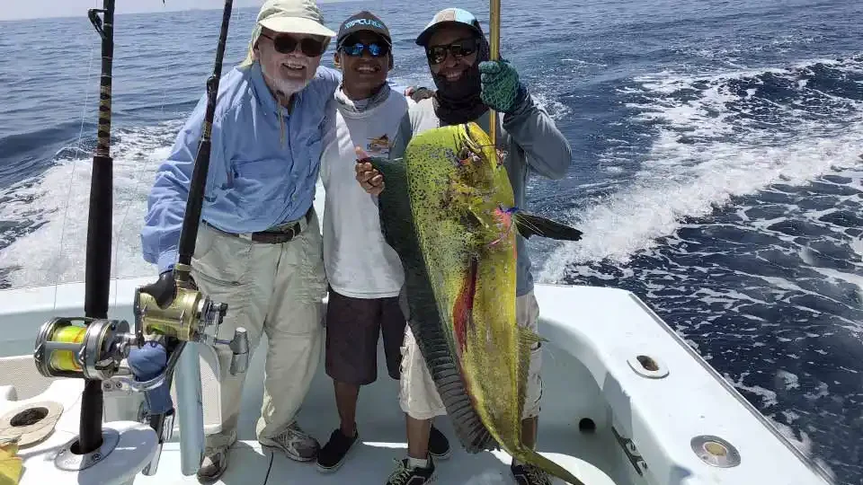 Angler and guides proudly displaying a large Mahi Mahi (Dorado) caught during a sportfishing trip in Guatemala at Sailfish Oasis Lodge.