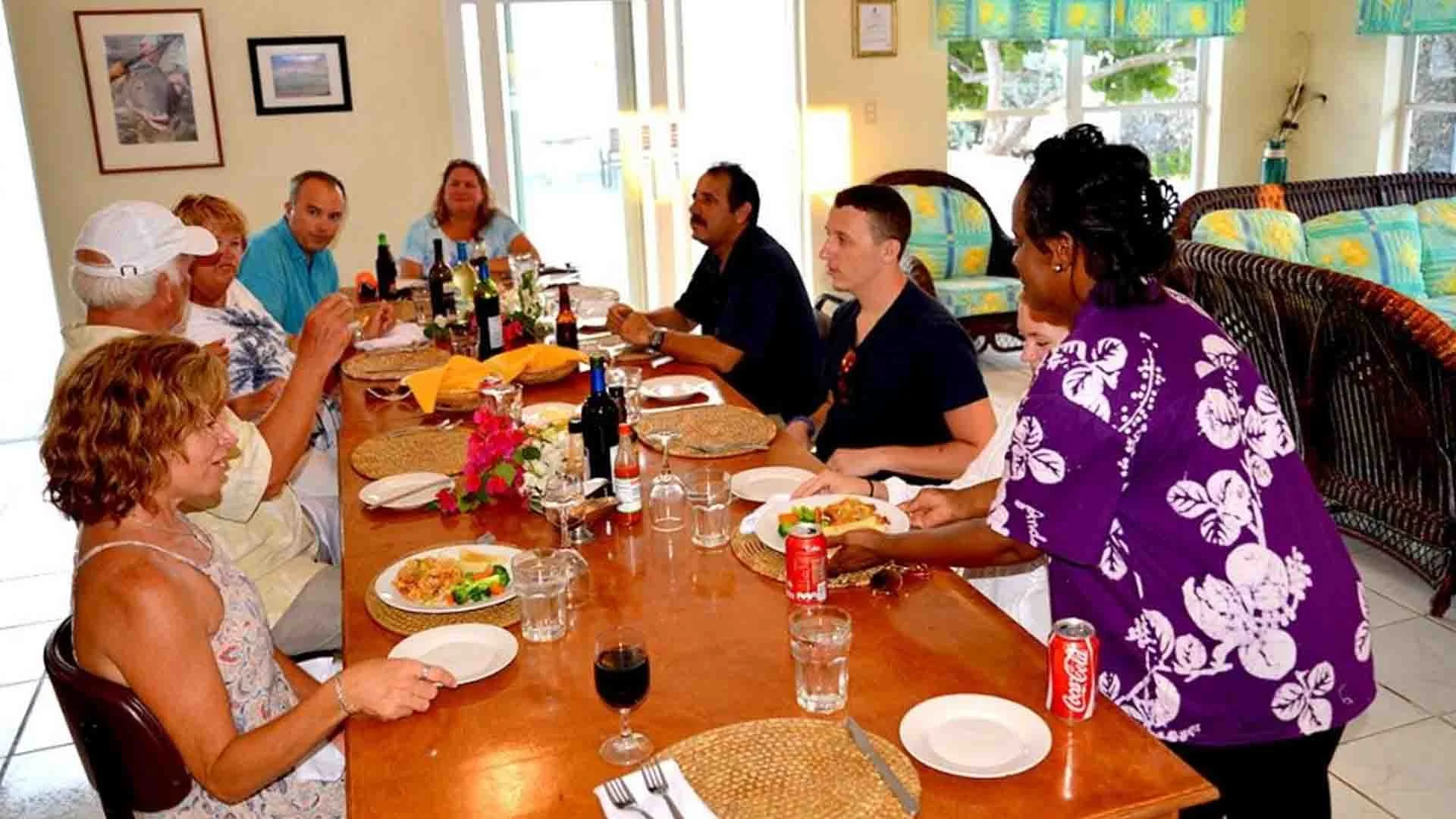 Guests enjoying dinner in the main dining room at Andros Island Bonefish Club, Bahamas.