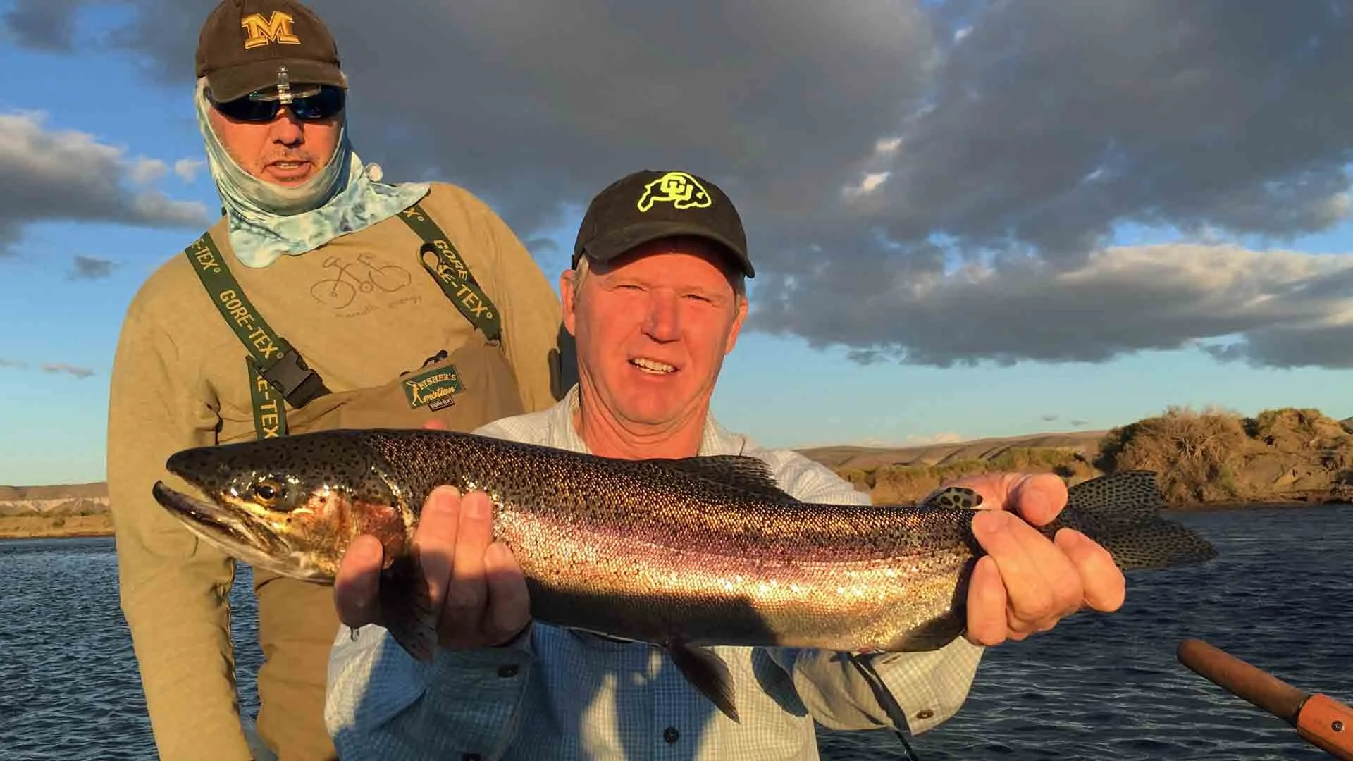 “Angler holding a beautiful hen rainbow trout caught on the Collon Cura River in Patagonia during a fly fishing trip.”