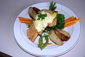 Steak dinner with steamed vegetables and potatoes served to guests at Turneffe Flats