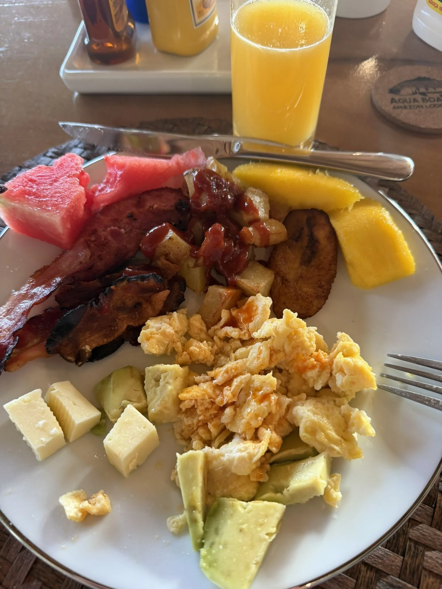 Enjoy a freshly prepared breakfast at Agua Boa Amazon Lodge featuring eggs, bacon, sausage, tropical fruit, and juice—served in the heart of the Brazilian Amazon.