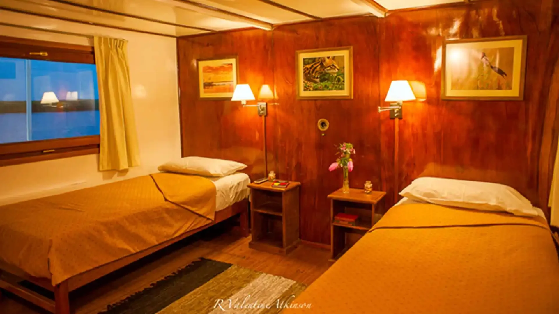 A cozy hotel room with two single beds, a window with yellow curtains, and wooden wall panels. Each bed has yellow bedding and a pillow. Between the beds are small wooden nightstands with lamps, flowers, and books. The room has framed artwork on the wall, and warm lighting creates a inviting atmosphere.