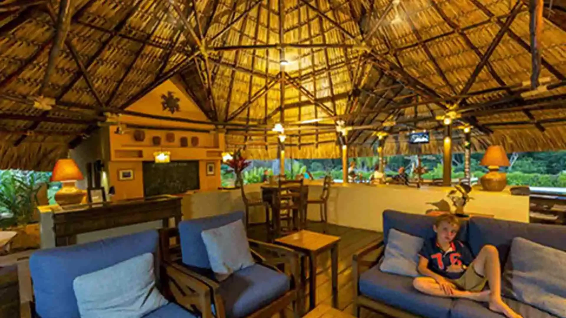 Covered lounge area at Sailfish Oasis Lodge with comfortable seating and ambient lighting for relaxing after a day of sailfishing