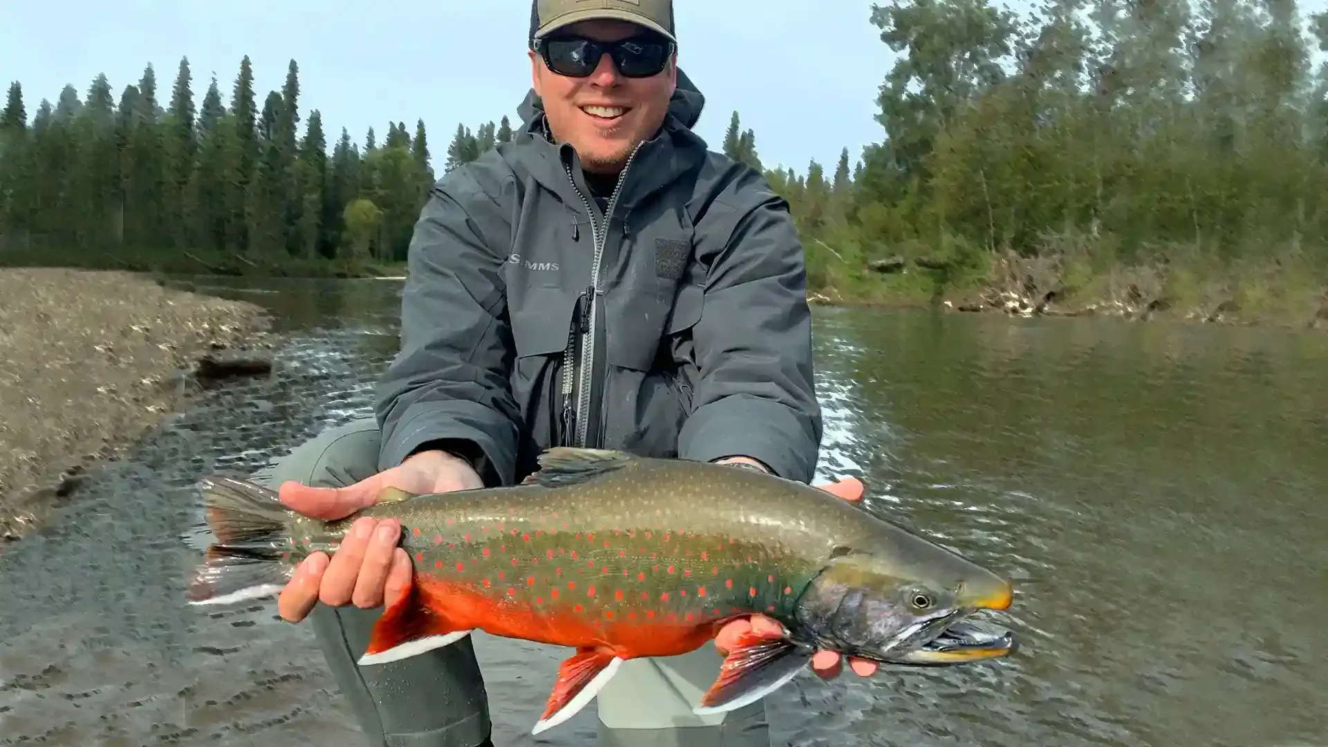 Angler holding a Dolly Varden caught on the Aniak River, Alaska