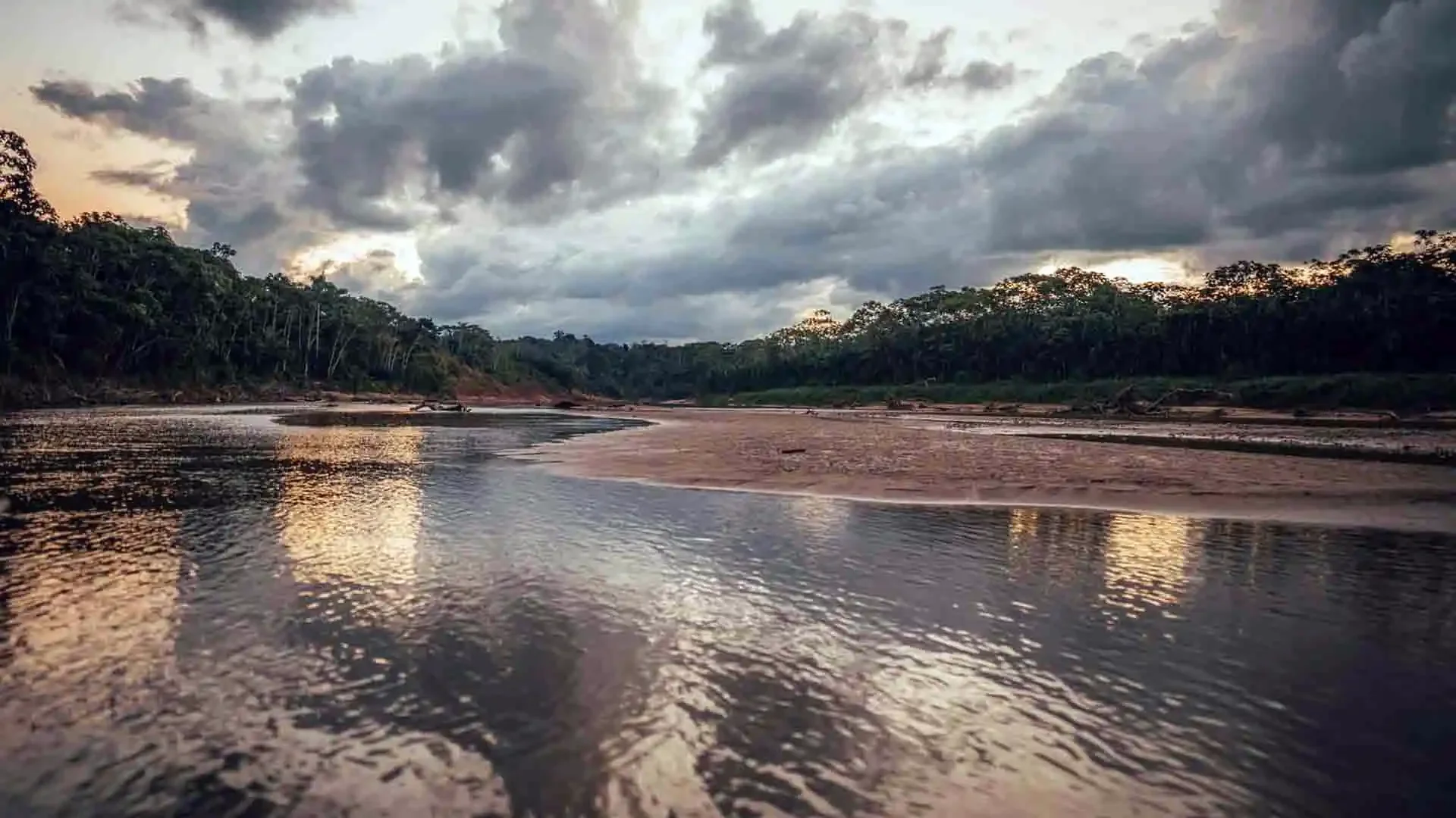 Scenic riverbank and clear water of the Secure River in Bolivia at sunset