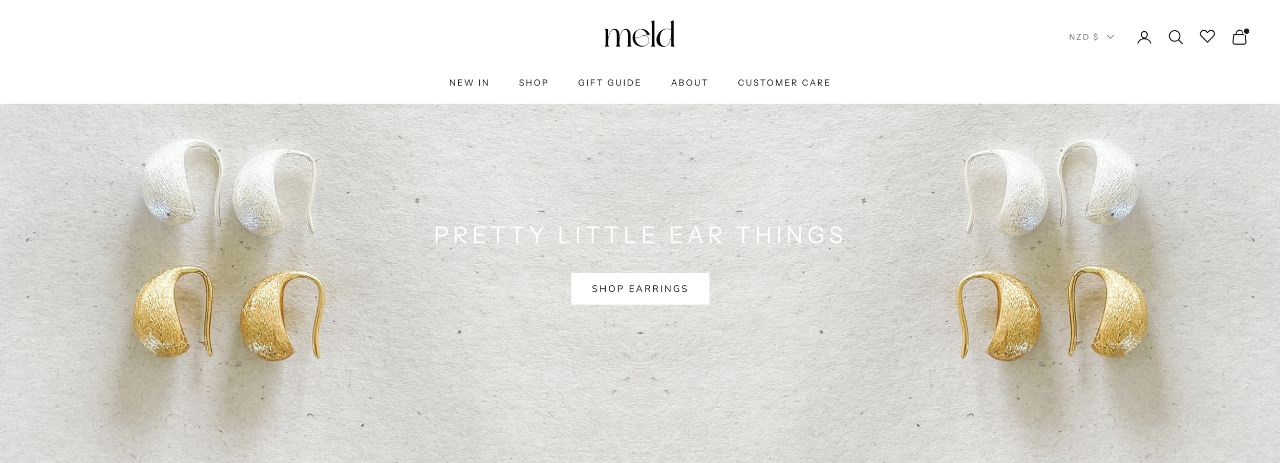 Meld Jewellery Shopify homepage featuring gold and silver statement earrings on a neutral background.