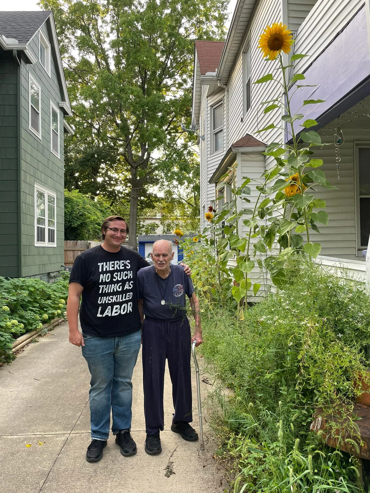 Justin Strekal with his grandpa showing off their sunflowers
