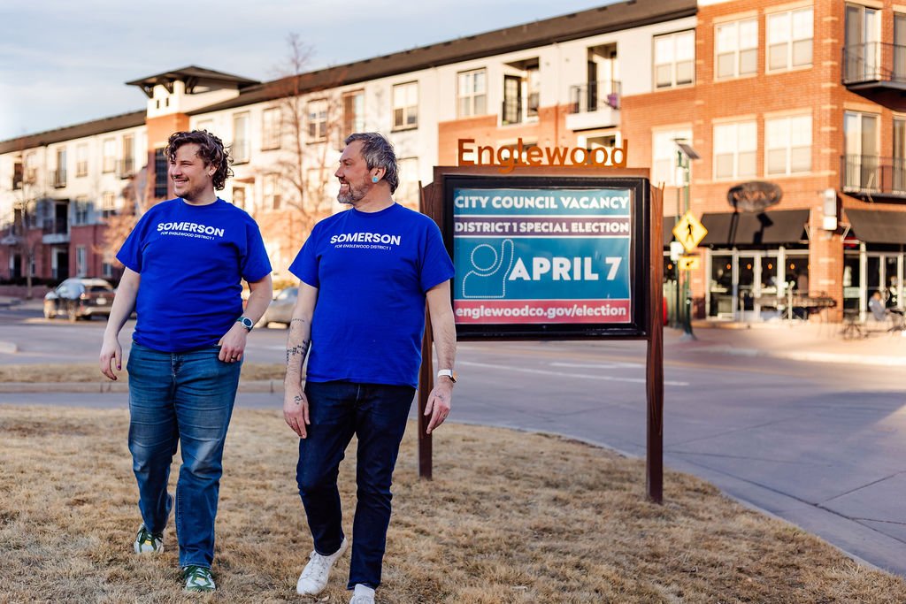 Picture of Rick and his husband Jacob walking in camapaign tee shirts