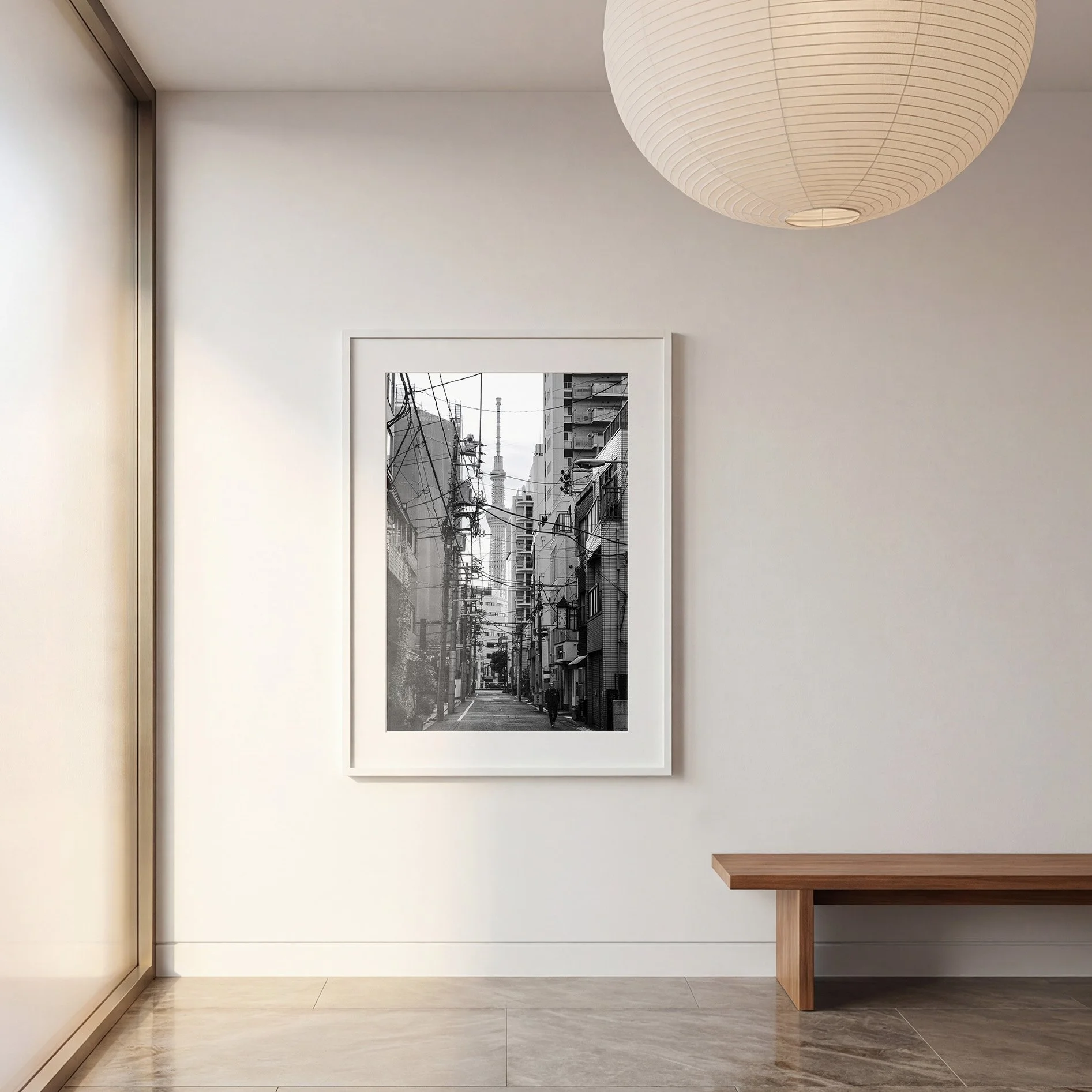 Black and white Tokyo Skytree photography print displayed in a white frame in a minimalist contemporary interior.