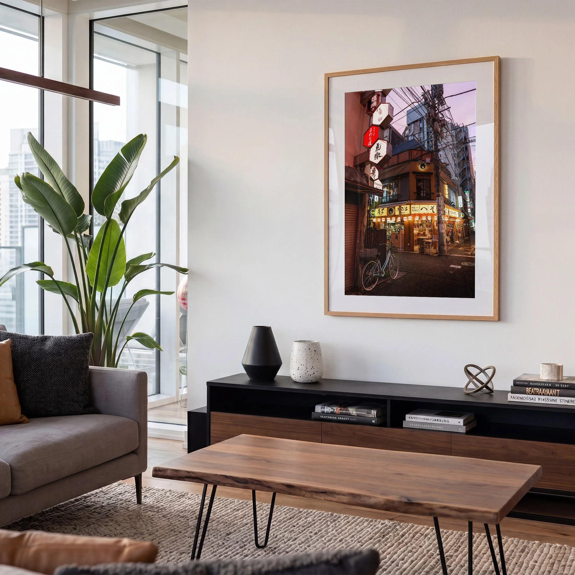 Tokyo restaurant street photography print displayed in an oak frame with white mat above a console in a contemporary apartment living room.