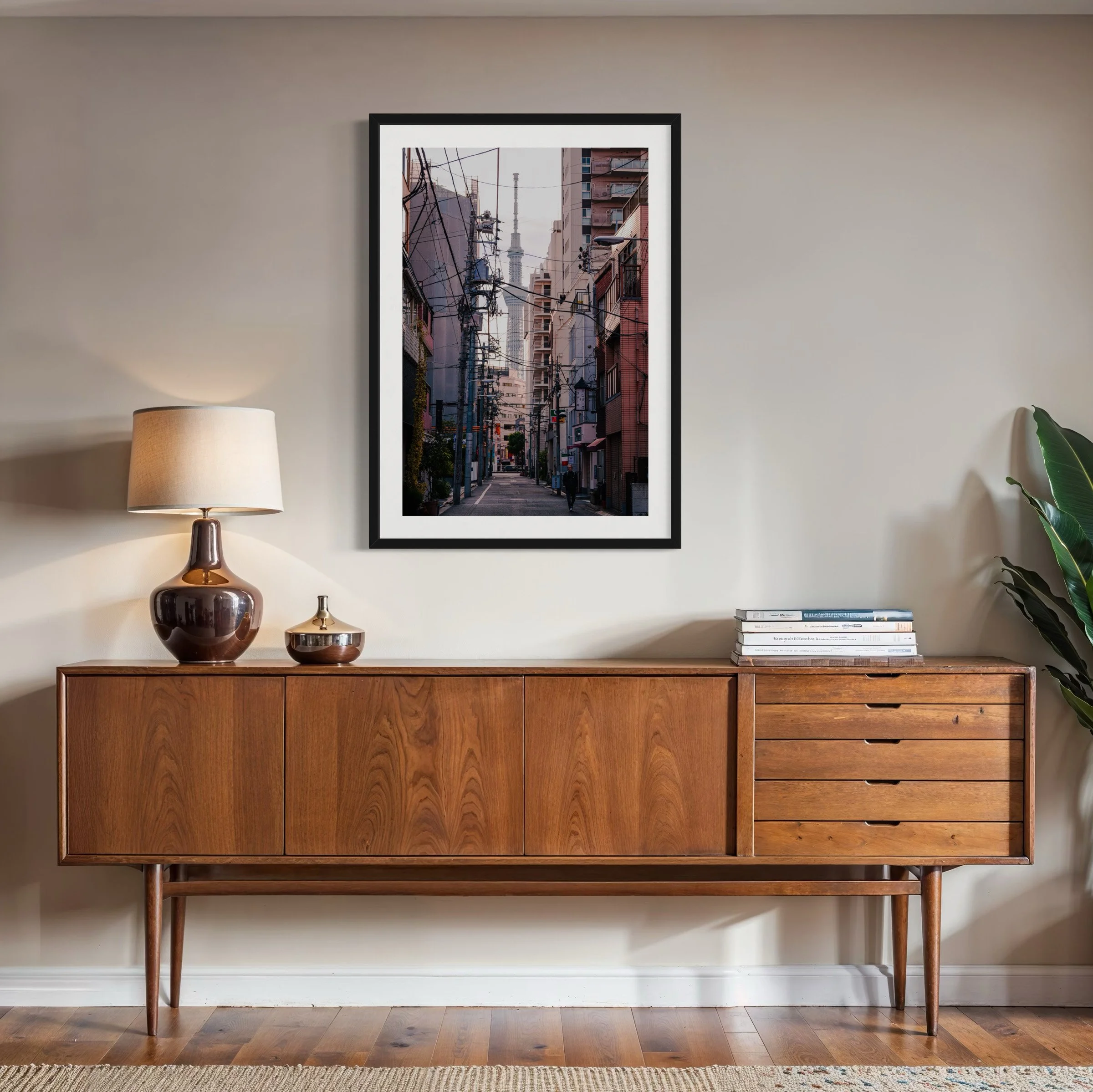 Vertical Tokyo alley wall art displayed above a mid-century timber sideboard with warm lighting and modern interior styling.