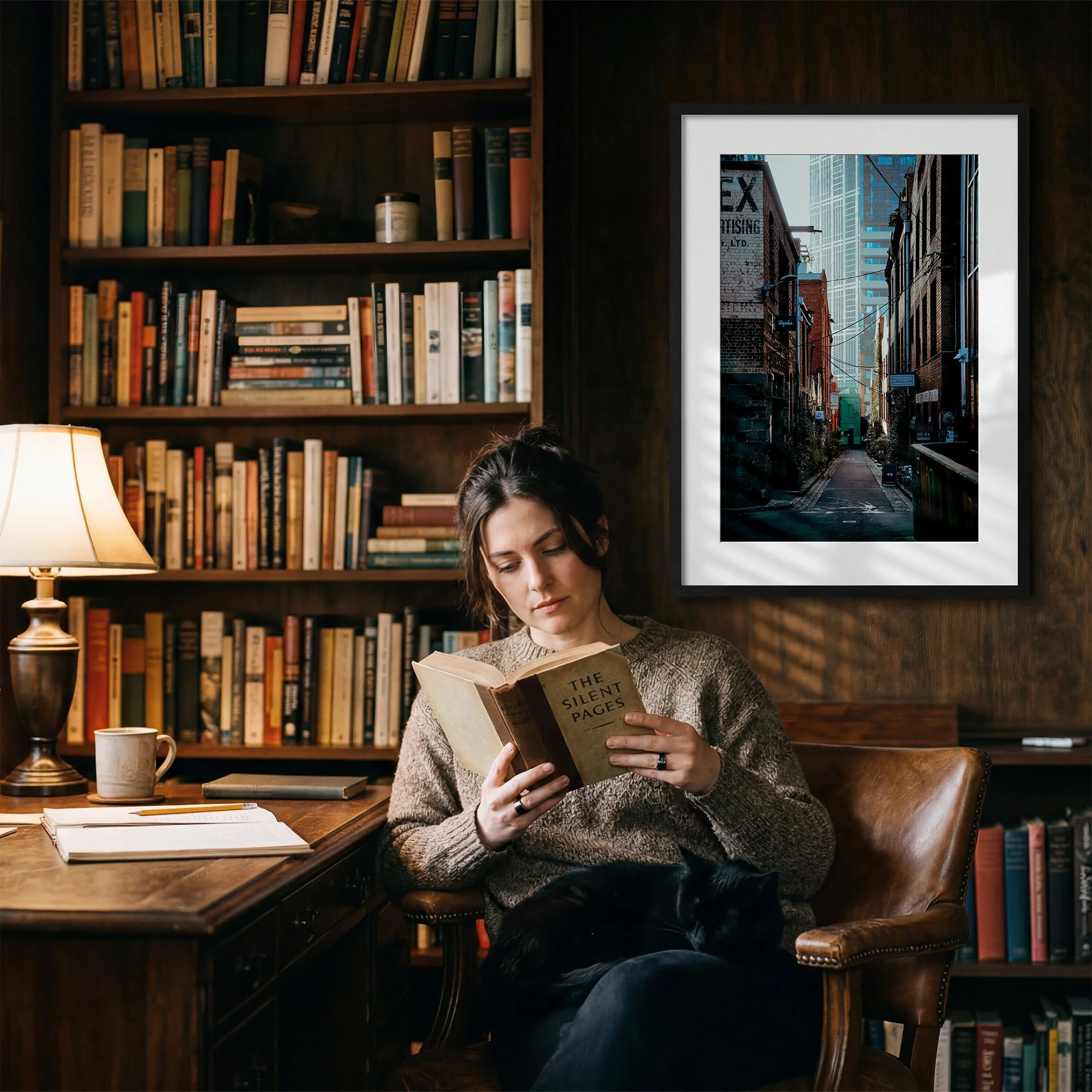Melbourne laneway photography print displayed in a black frame with white mat in a warm, timber-lined home library.