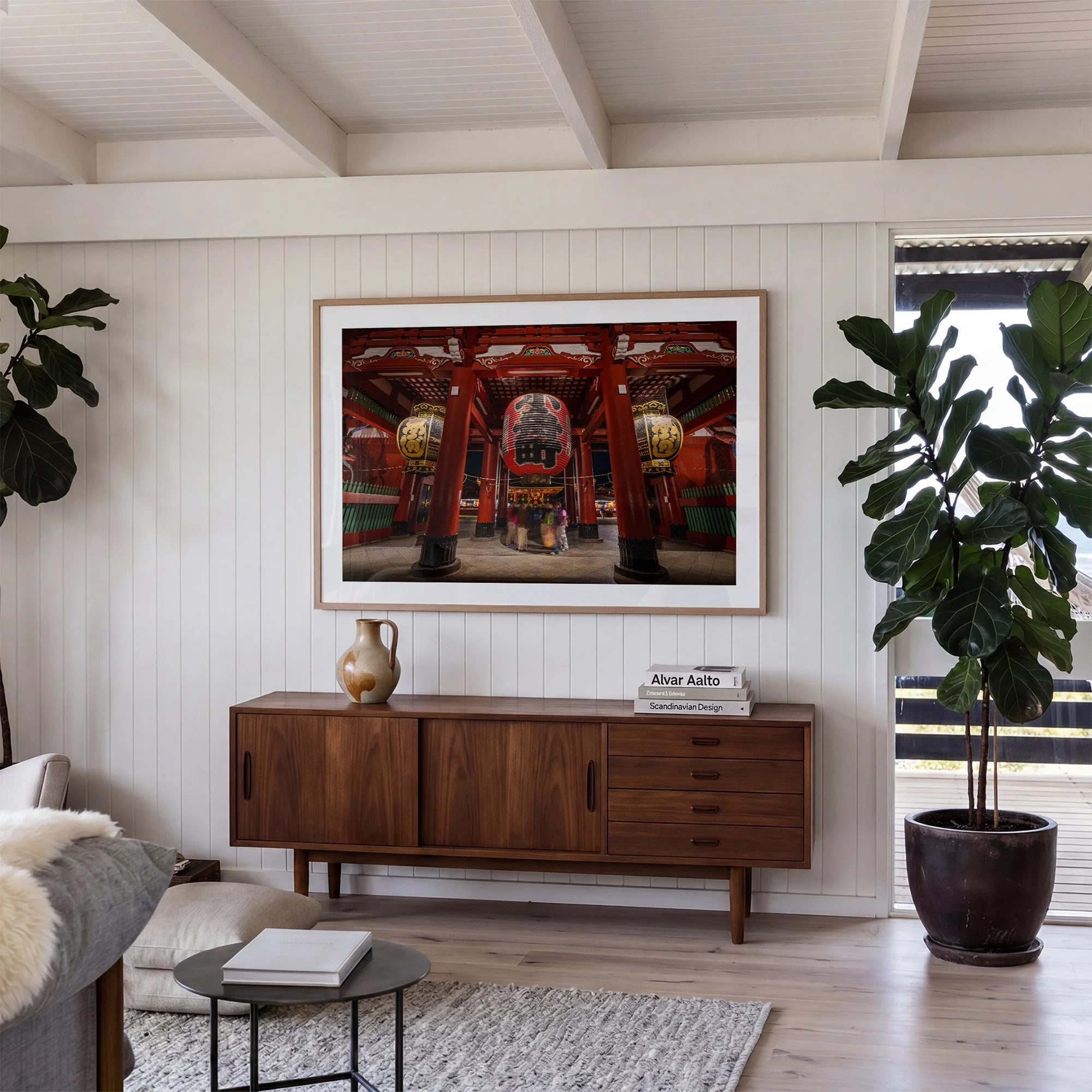 Tokyo temple photography print featuring the lanterns and red architecture of Sensō-ji, displayed in an oak frame above a timber sideboard in a bright contemporary interior.
