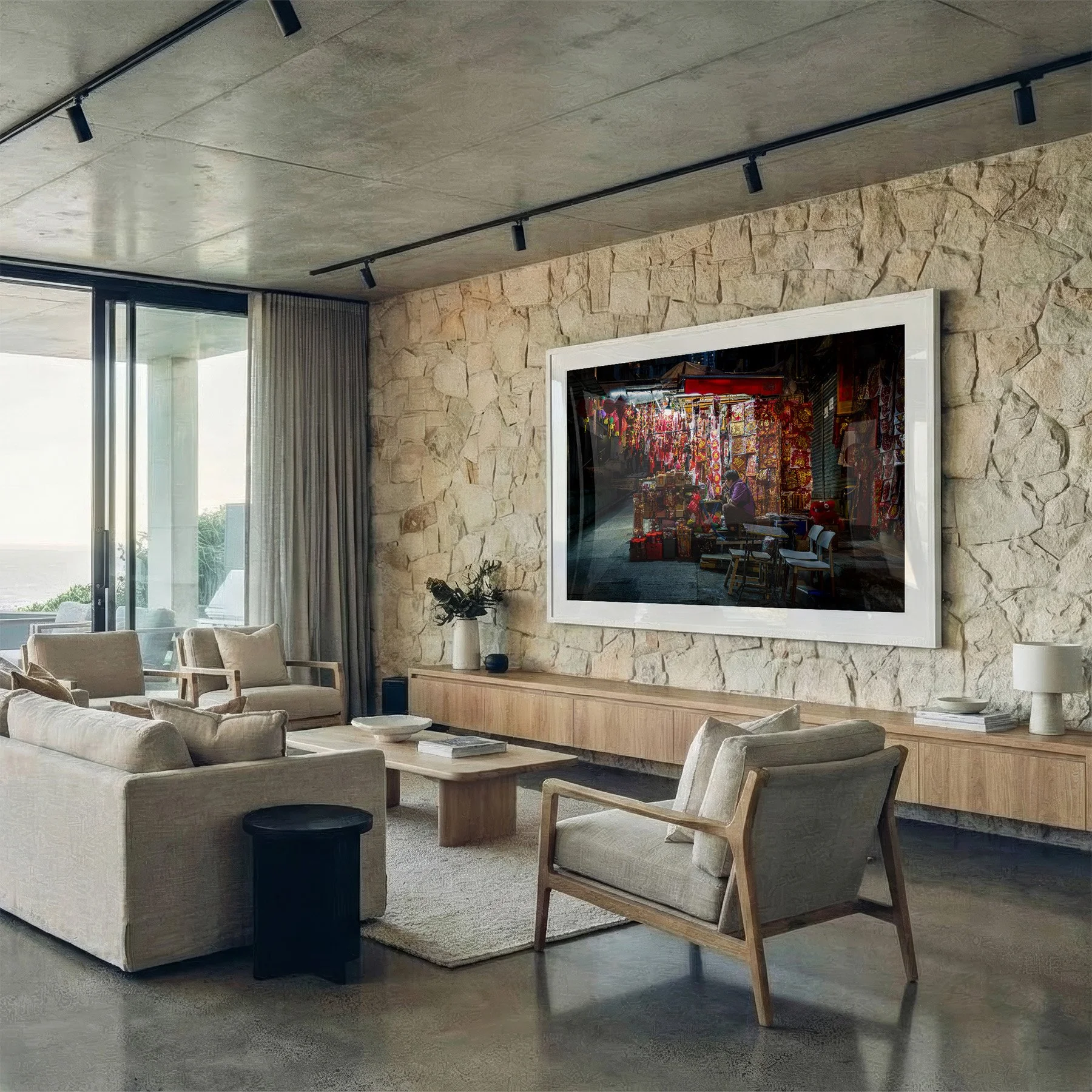 Hong Kong street photography print featuring a colourful night market stall, displayed in a white frame on a stone wall in a contemporary living room.