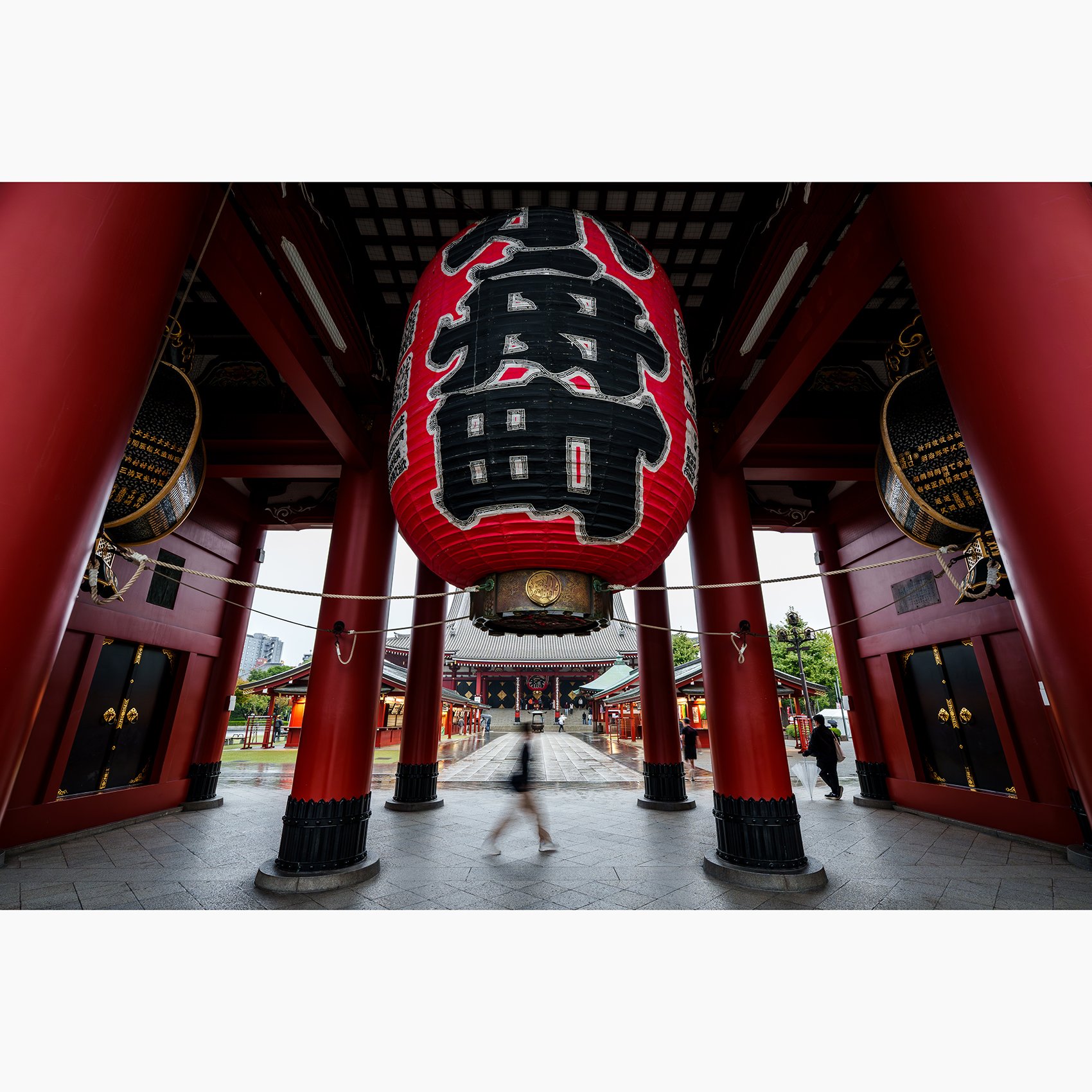 Blurred figure walking beneath the giant lantern at Sensō-ji Temple in Tokyo, Japan.