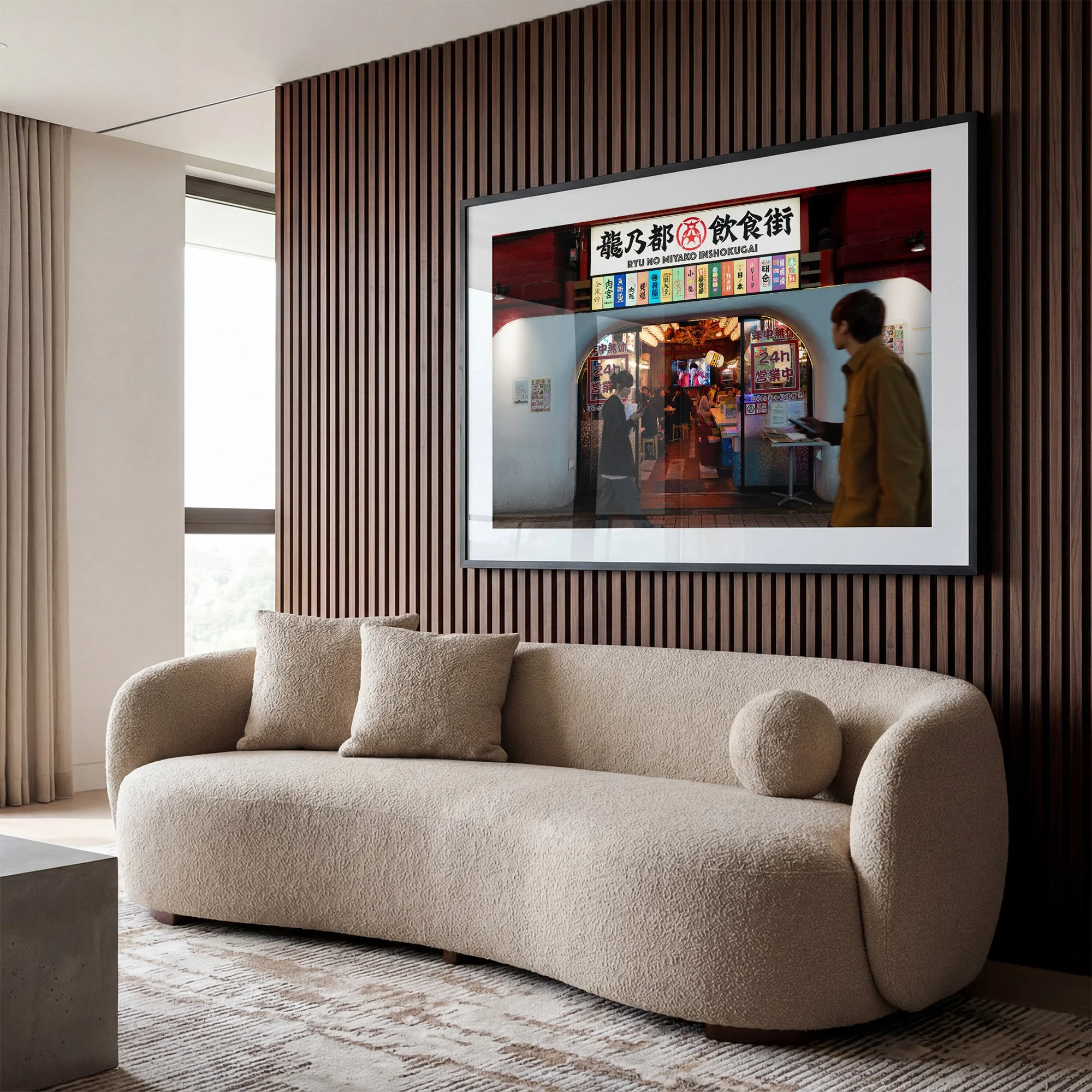 Tokyo street photography print of Ryu No Miyako dining street displayed in a black frame with white mat above a cream sofa in a contemporary timber-panelled living room.
