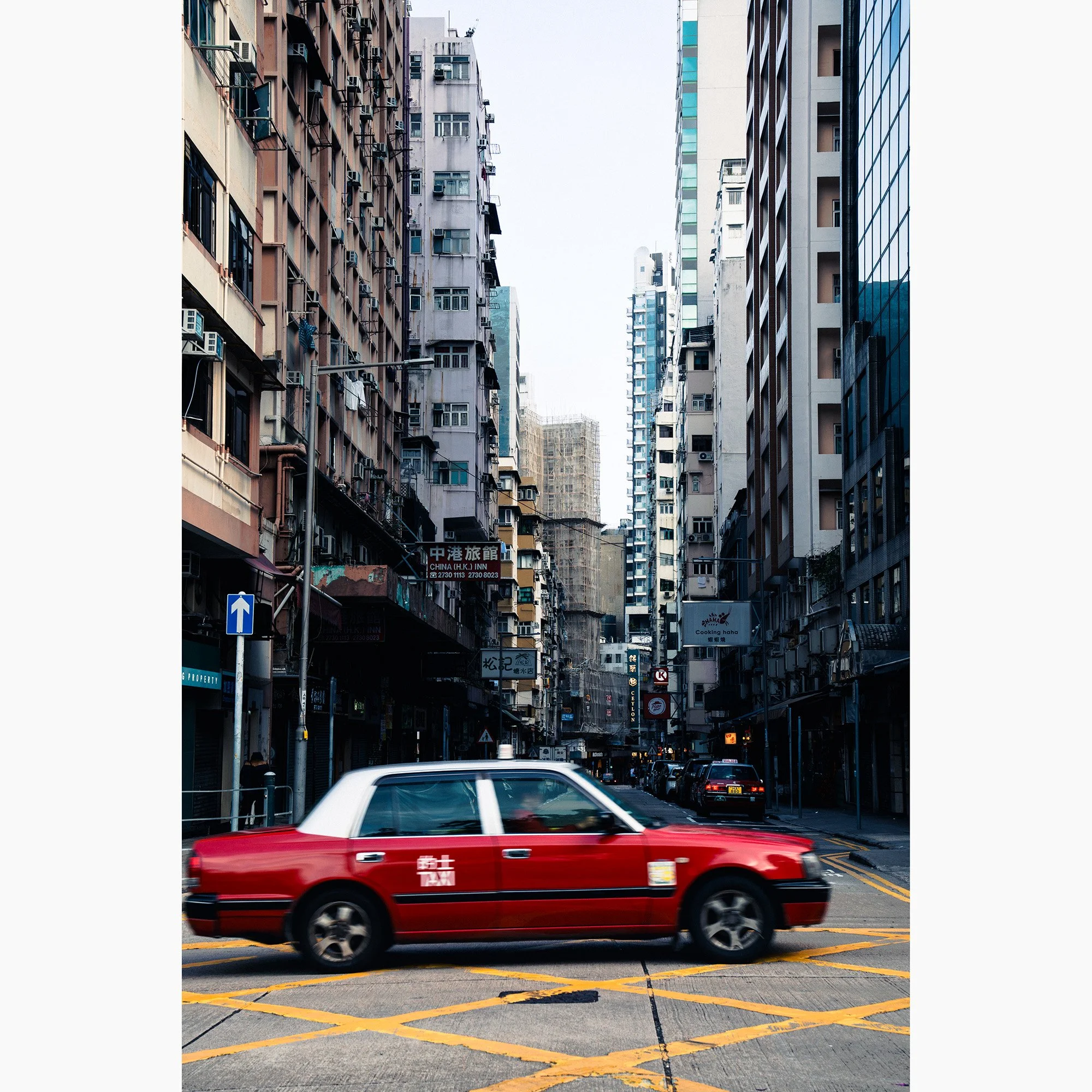 Full vertical artwork view of Hong Kong Taxi Rush showing motion blur, dense apartment towers and layered urban detail.