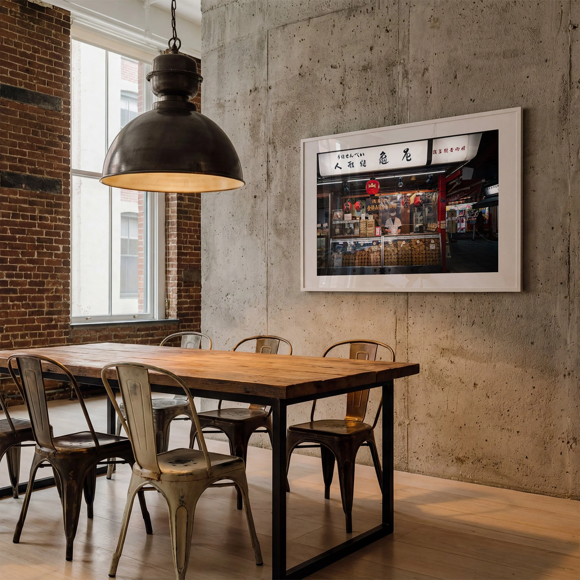 Tokyo street photography print of a traditional Asakusa senbei shop, displayed in a white frame with mat in an industrial concrete and brick dining room.