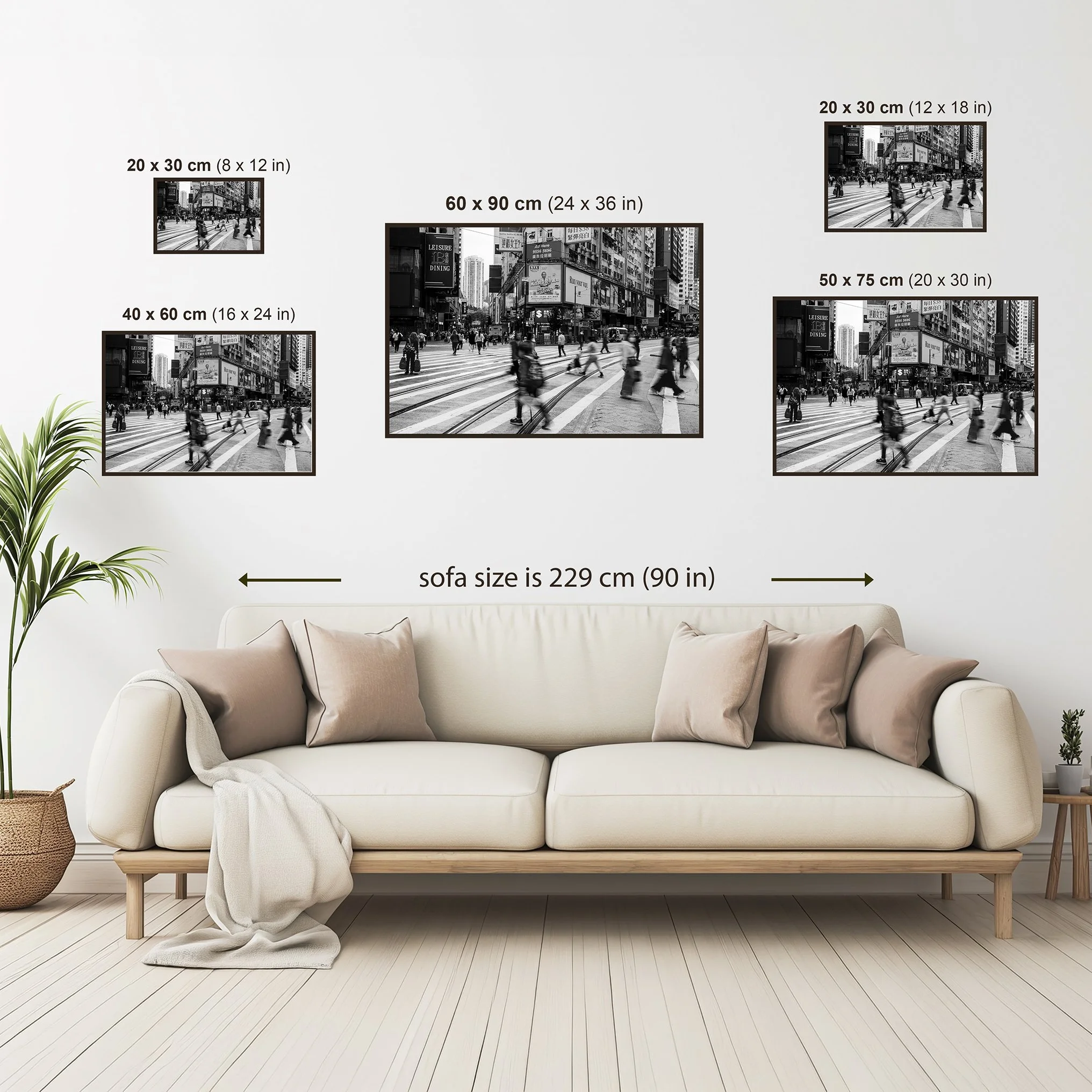 Size guide showing the Hong Kong street photography print above a beige sofa, comparing available print sizes from 20 × 30 cm (8 × 12 in) to 60 × 90 cm (24 × 36 in) for wall scale reference.