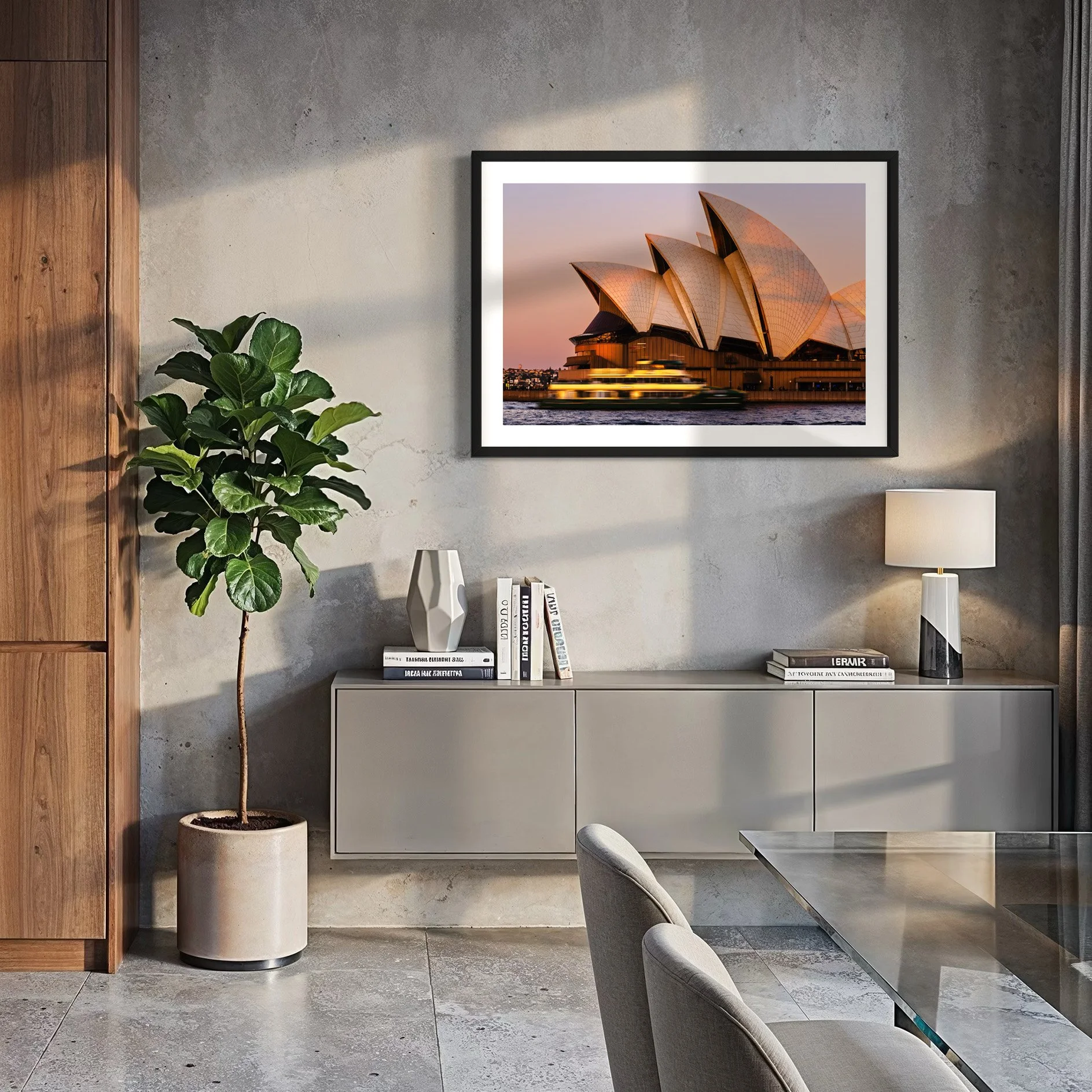 Framed Sydney Opera House sunset photograph displayed in a contemporary concrete and timber dining room.