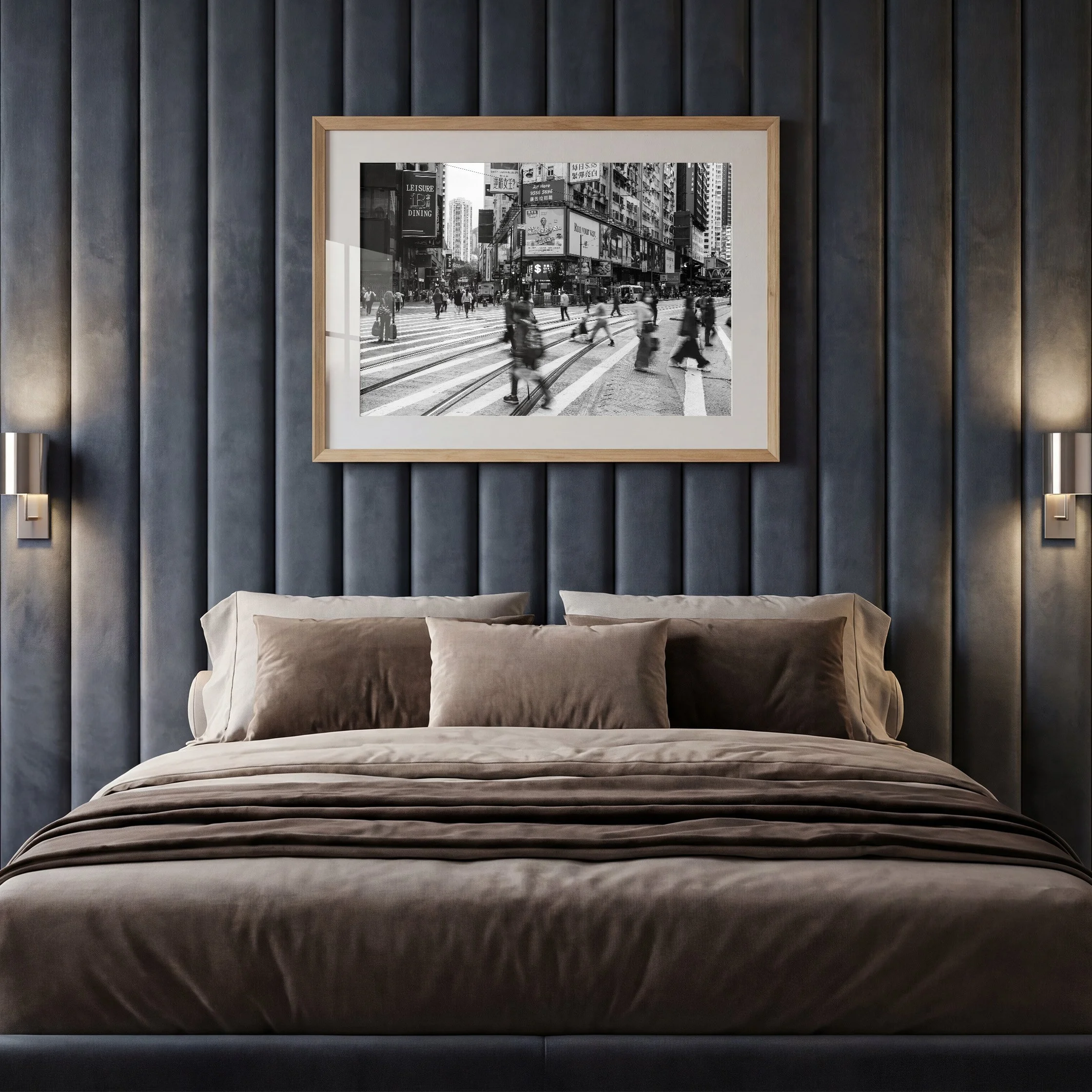 Black and white Hong Kong street photography print displayed in an oak frame with white mat above a bed in a dark contemporary bedroom.