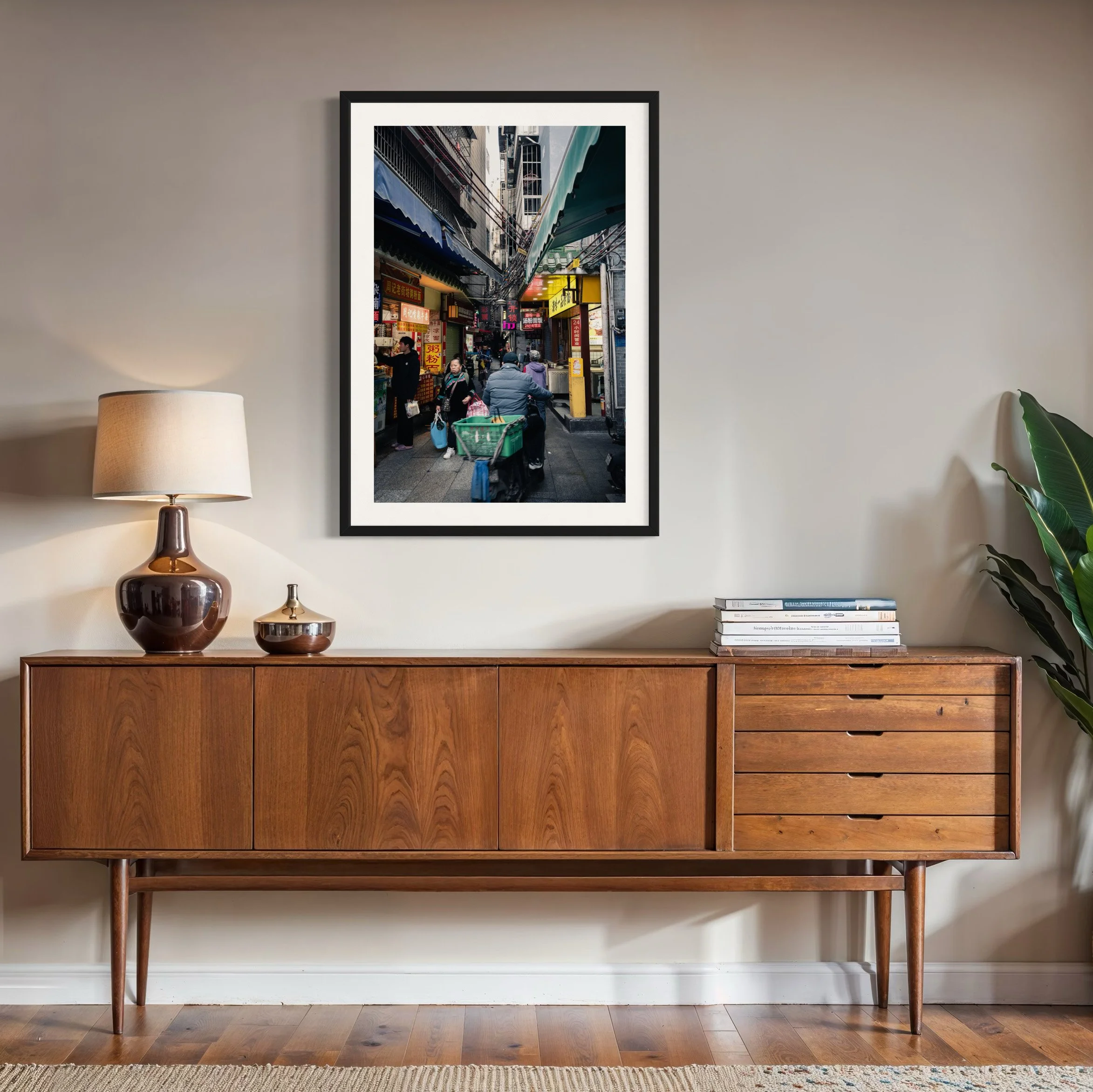 Framed Guangzhou alley street photography print displayed above a mid-century timber sideboard in a contemporary living space with warm wood tones and neutral décor.