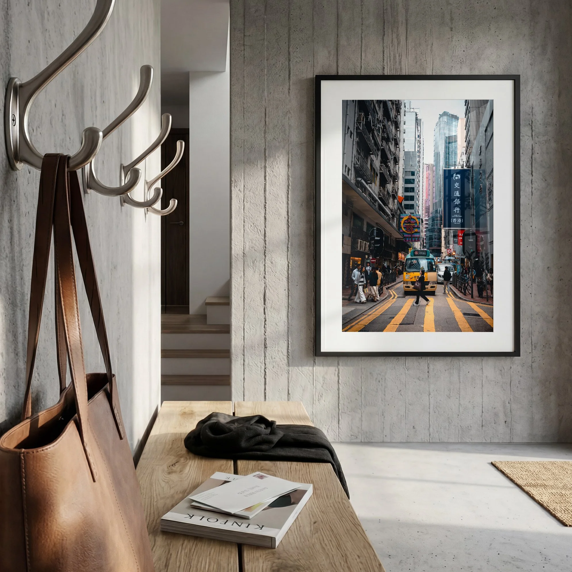 Hong Kong street photography print featuring a yellow minibus, displayed in a black frame with white mat in a contemporary concrete entryway.