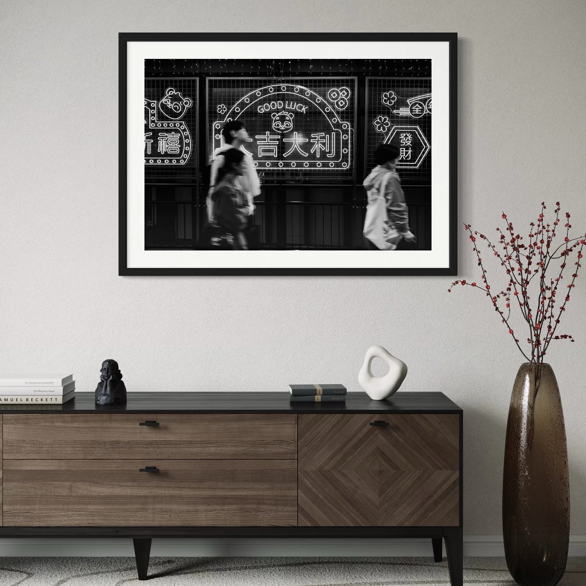 Framed black and white Hong Kong street photography print displayed above a wooden sideboard in a warm minimalist living space.