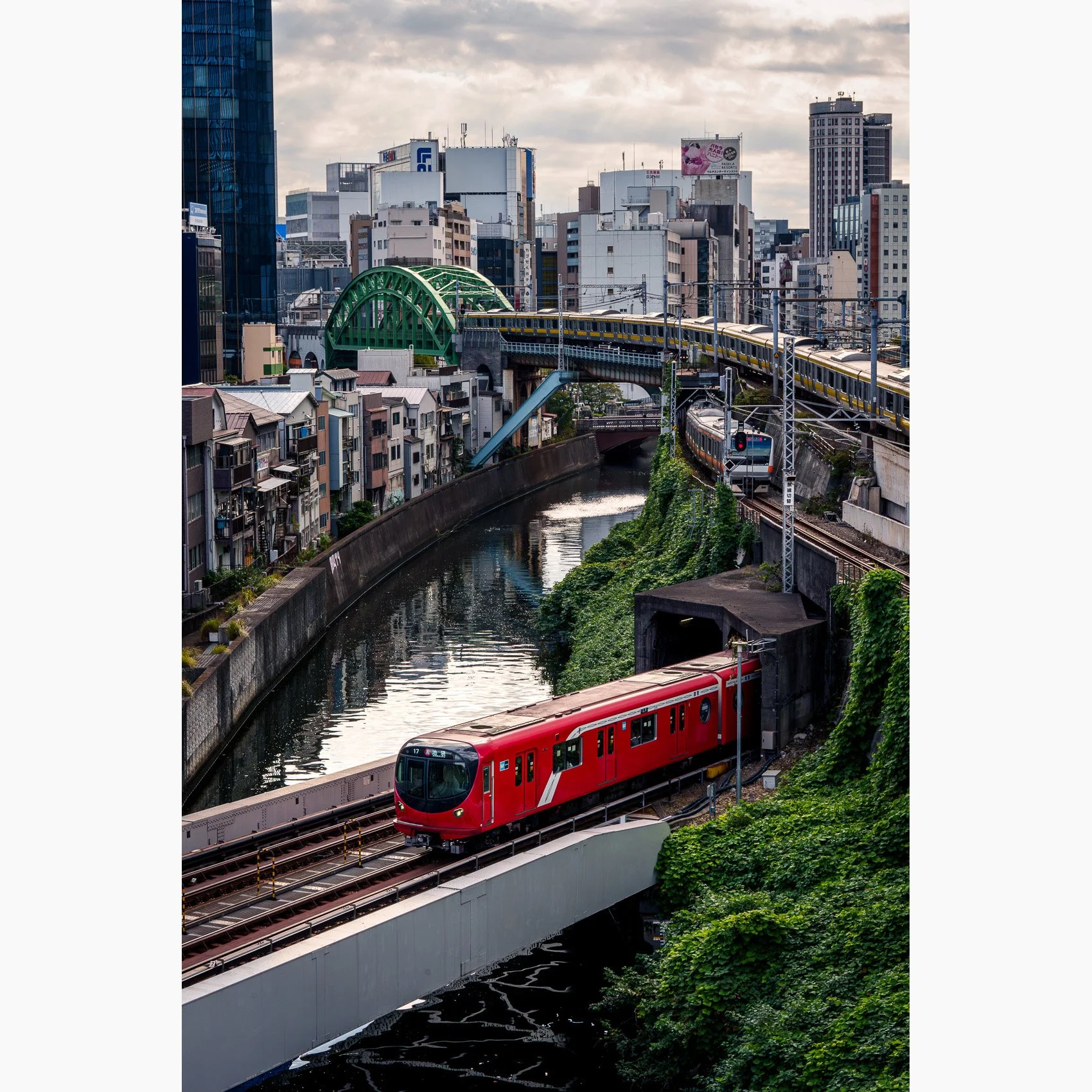 Fine art photograph of three railway lines, a canal and layered city architecture near Hijiribashi in Tokyo, Japan.