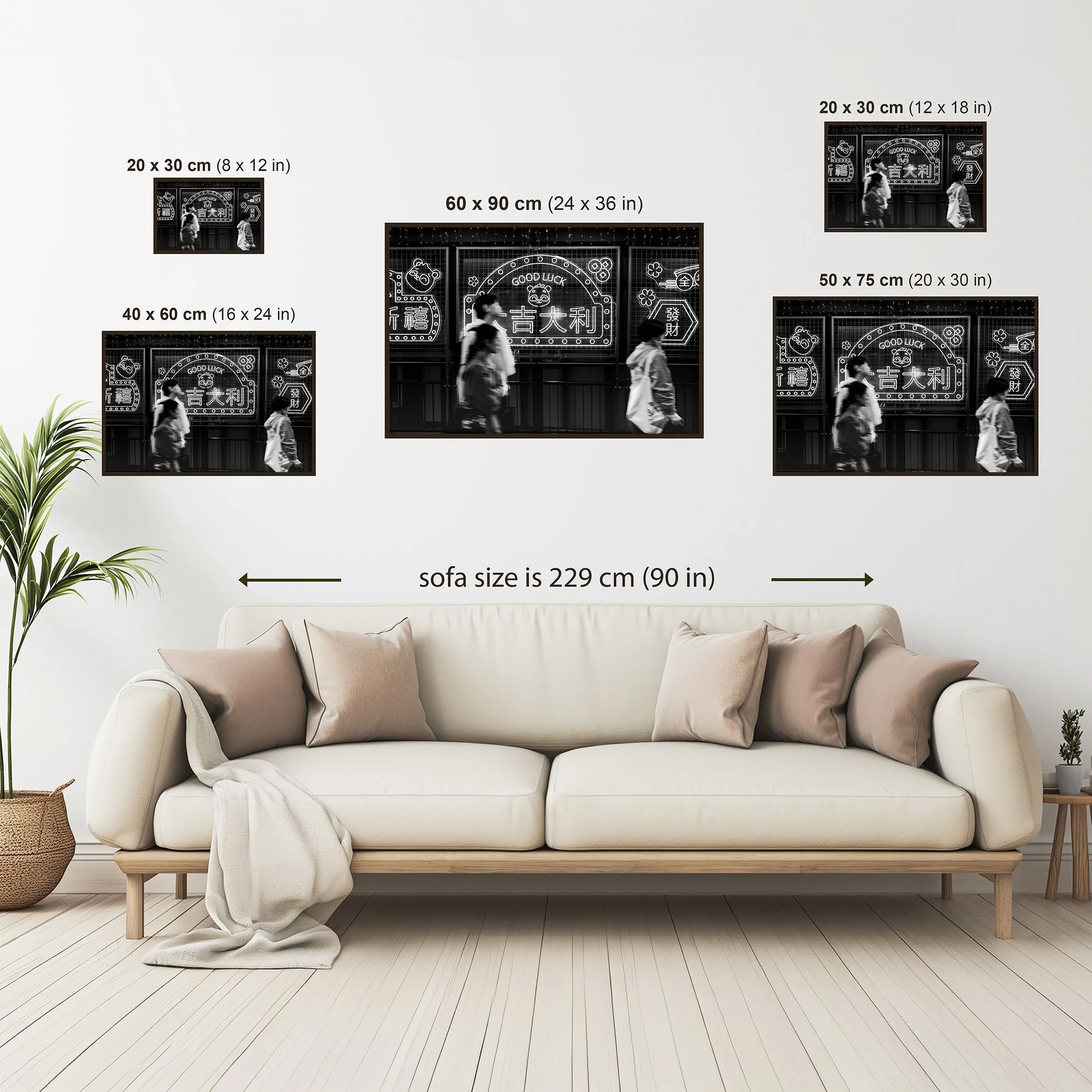 Wall art size comparison guide showing available print sizes for a black and white Hong Kong street photography print above a sofa for scale reference.