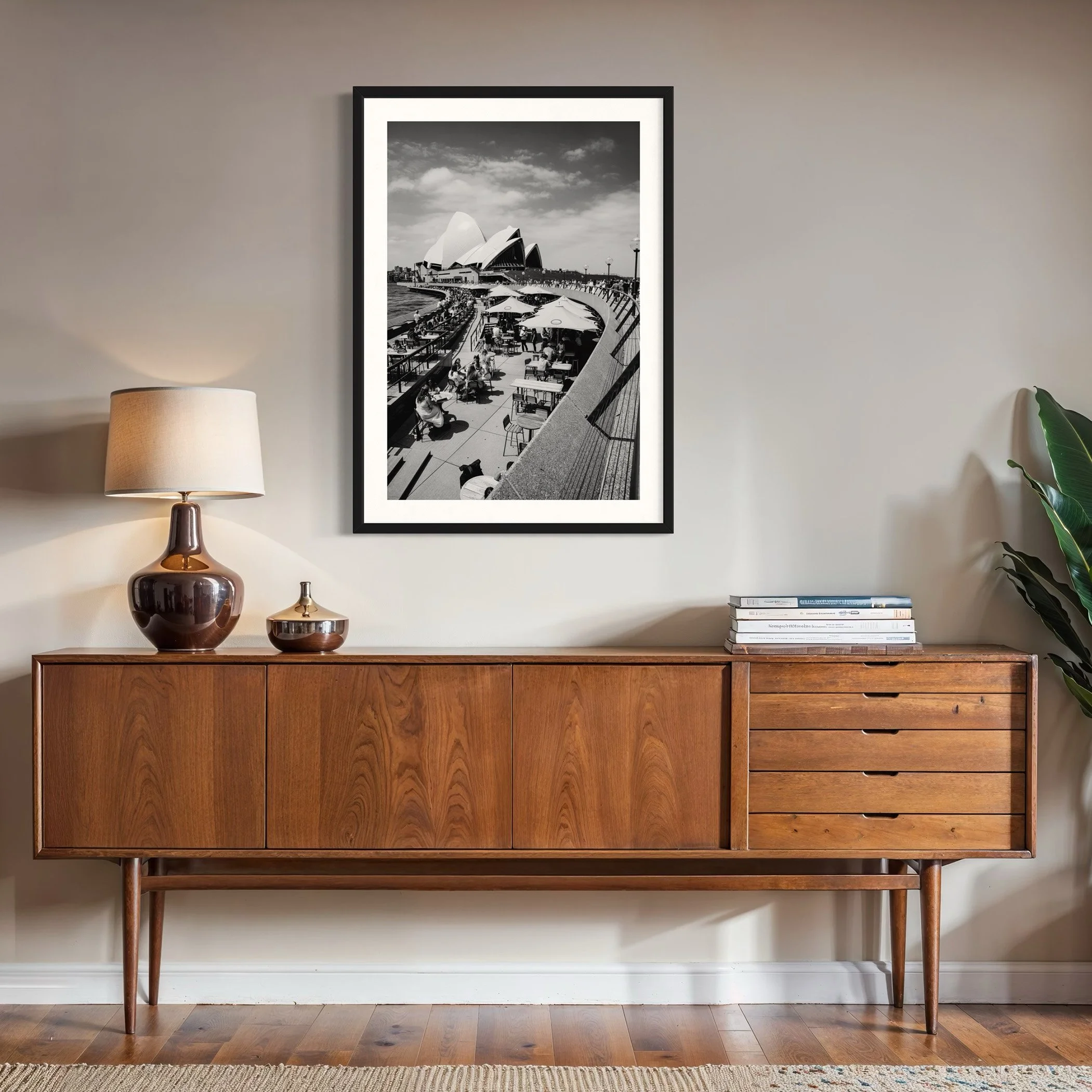 Framed Sydney Opera House photographic print displayed above a mid-century timber sideboard, showcasing Sydney harbour architecture in a modern living space.
