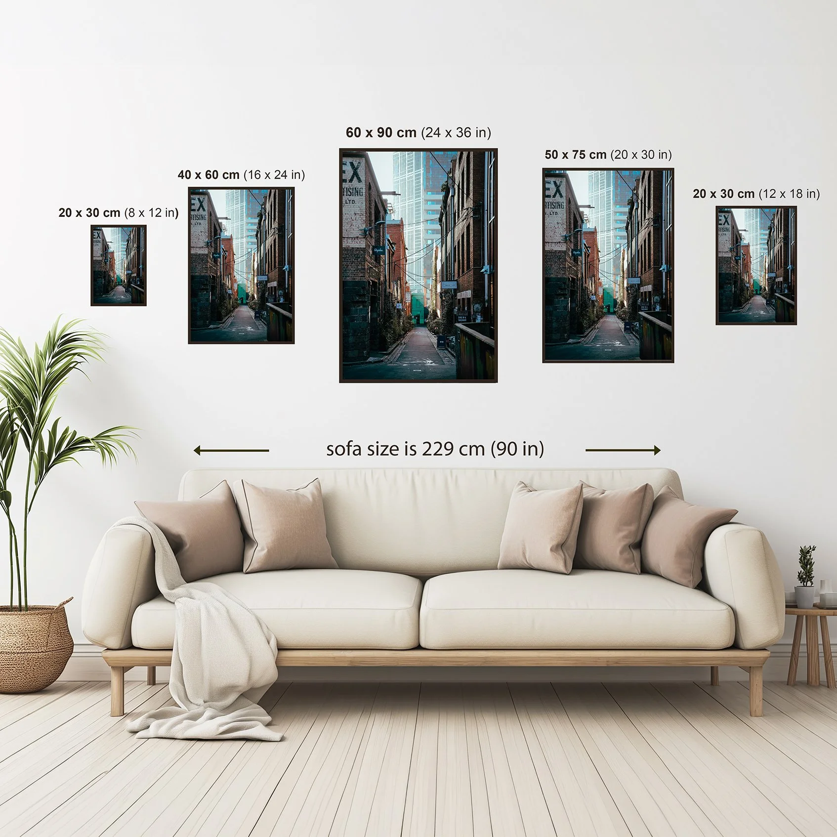 Wall art size guide showing available portrait print sizes above a sofa for scale reference.
