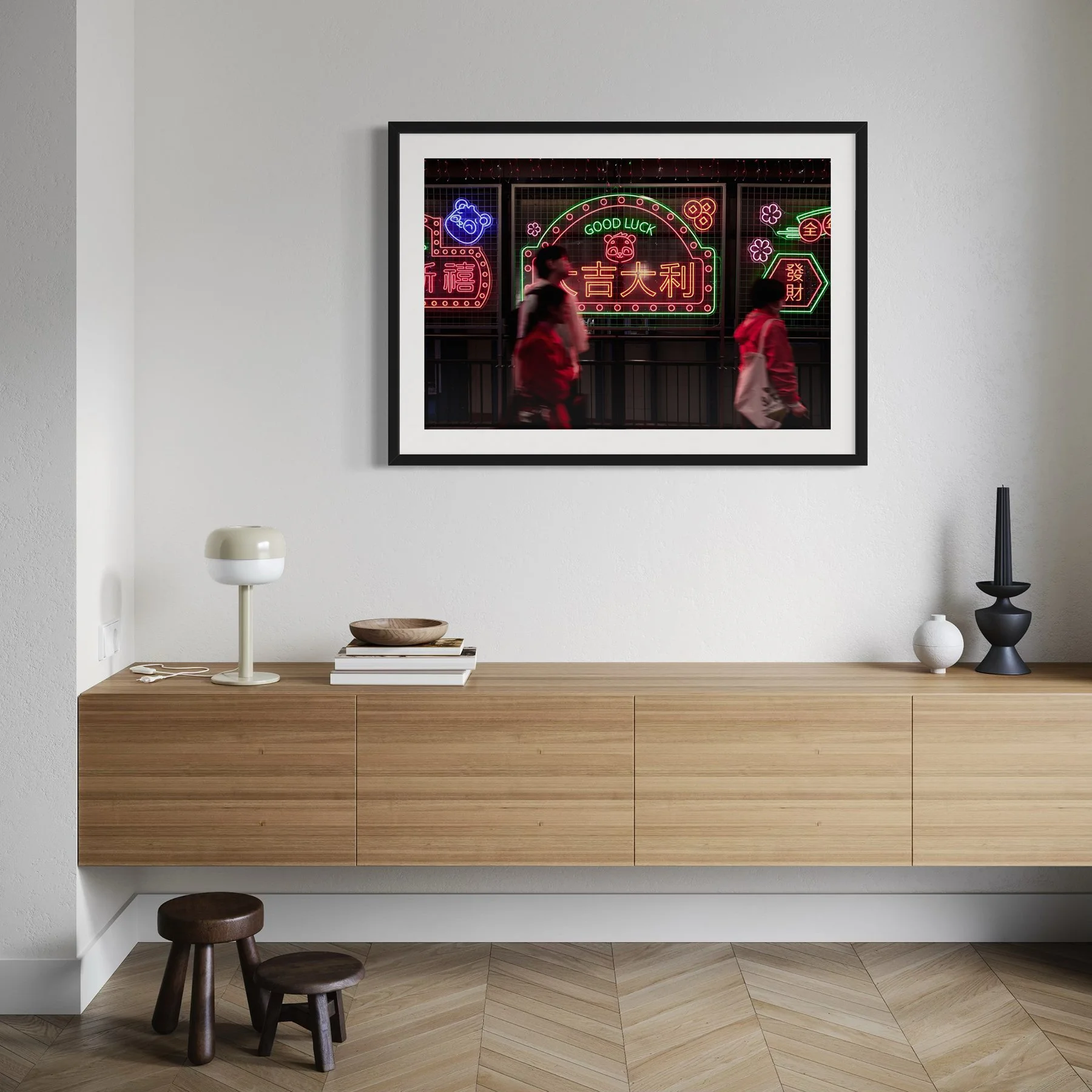 Modern interior with a floating wooden sideboard and framed Hong Kong neon street photography print above, showing blurred pedestrians beneath colourful neon signage.